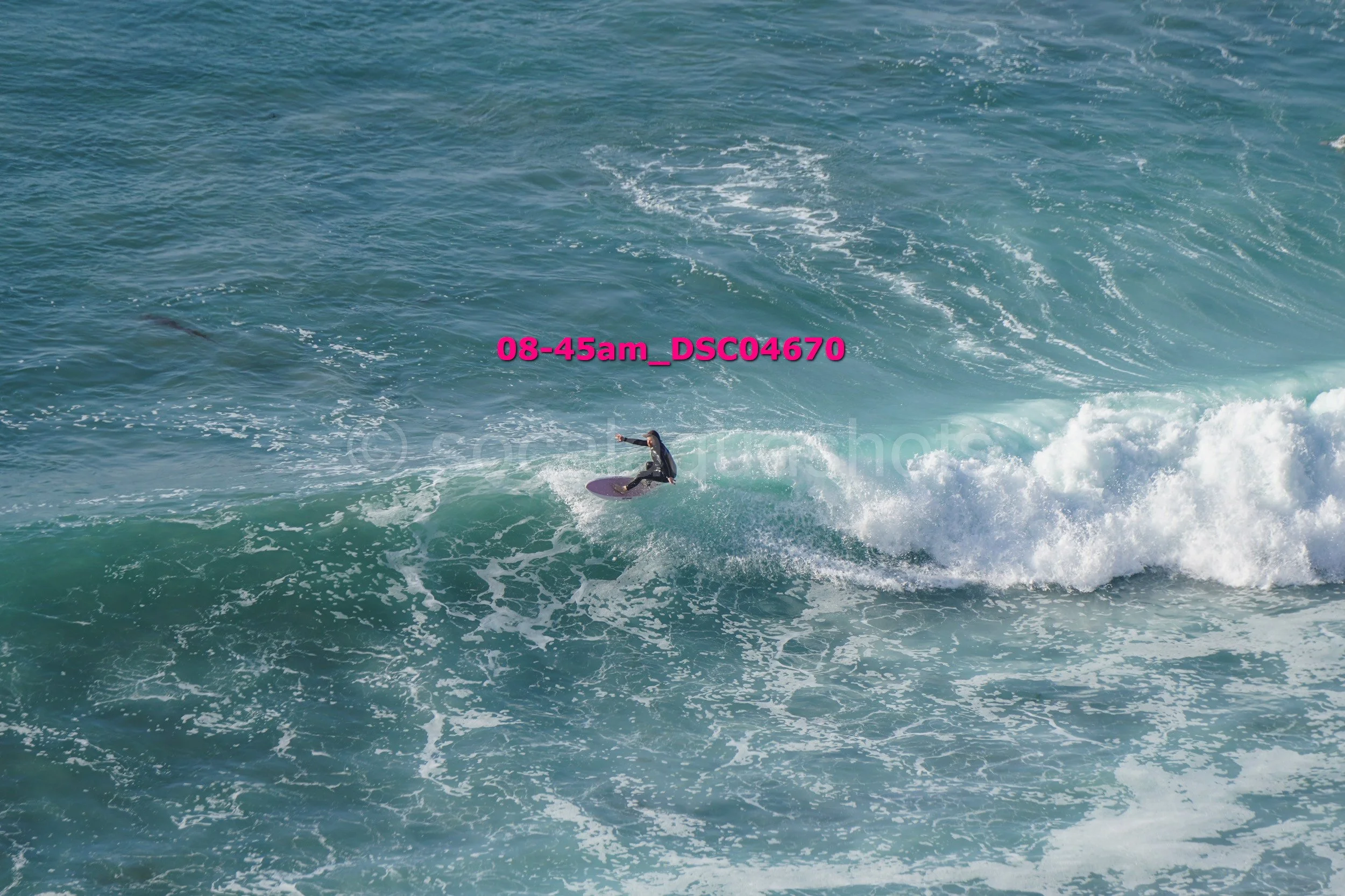 A person surfing on a wave in the ocean