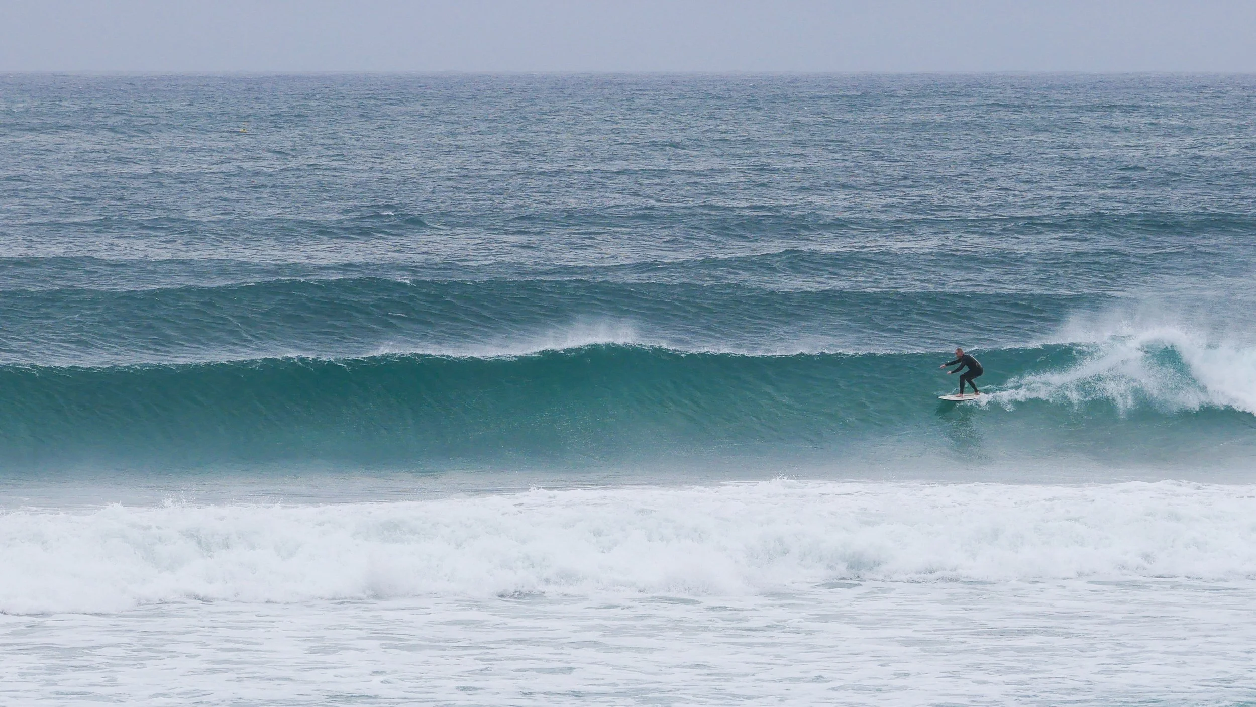 Surfer riding a large ocean wave