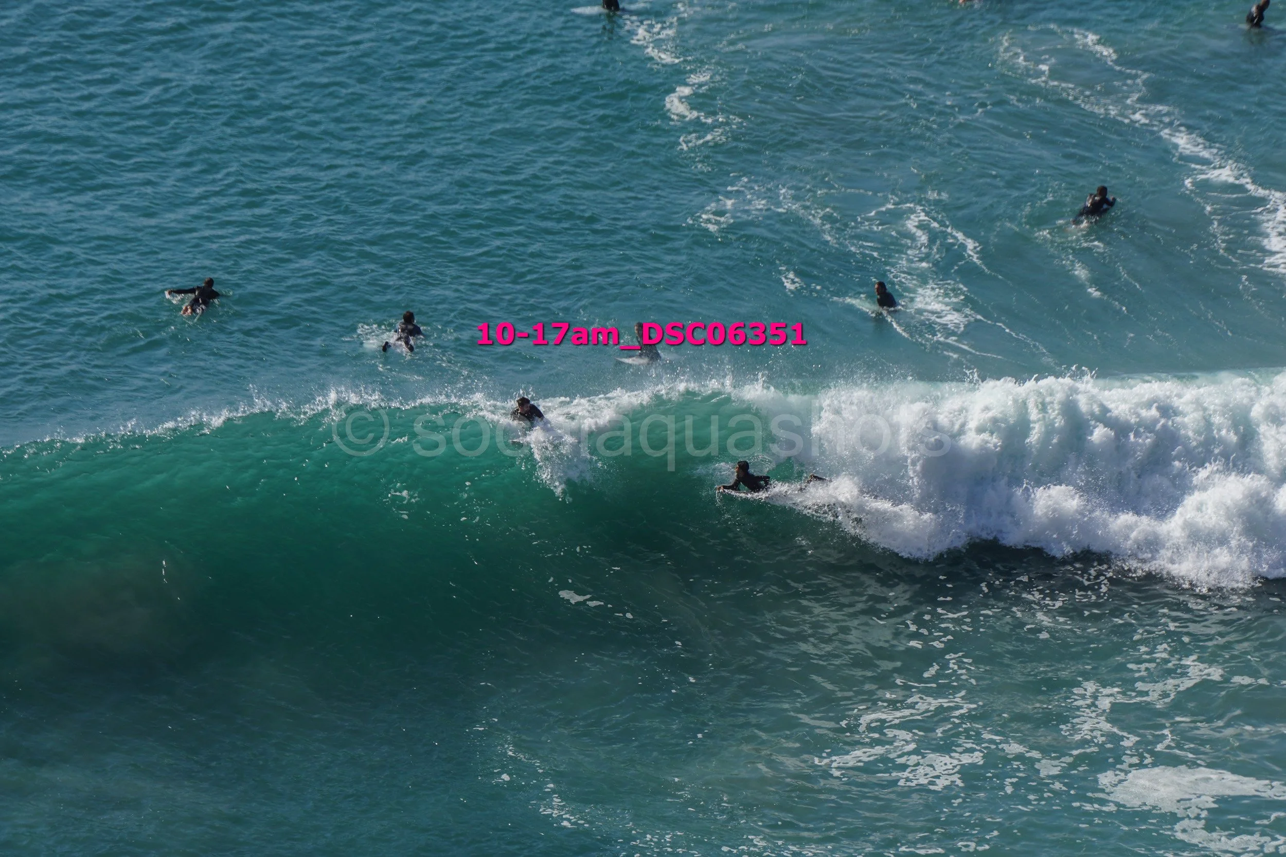 Group of people surfing on the ocean waves.