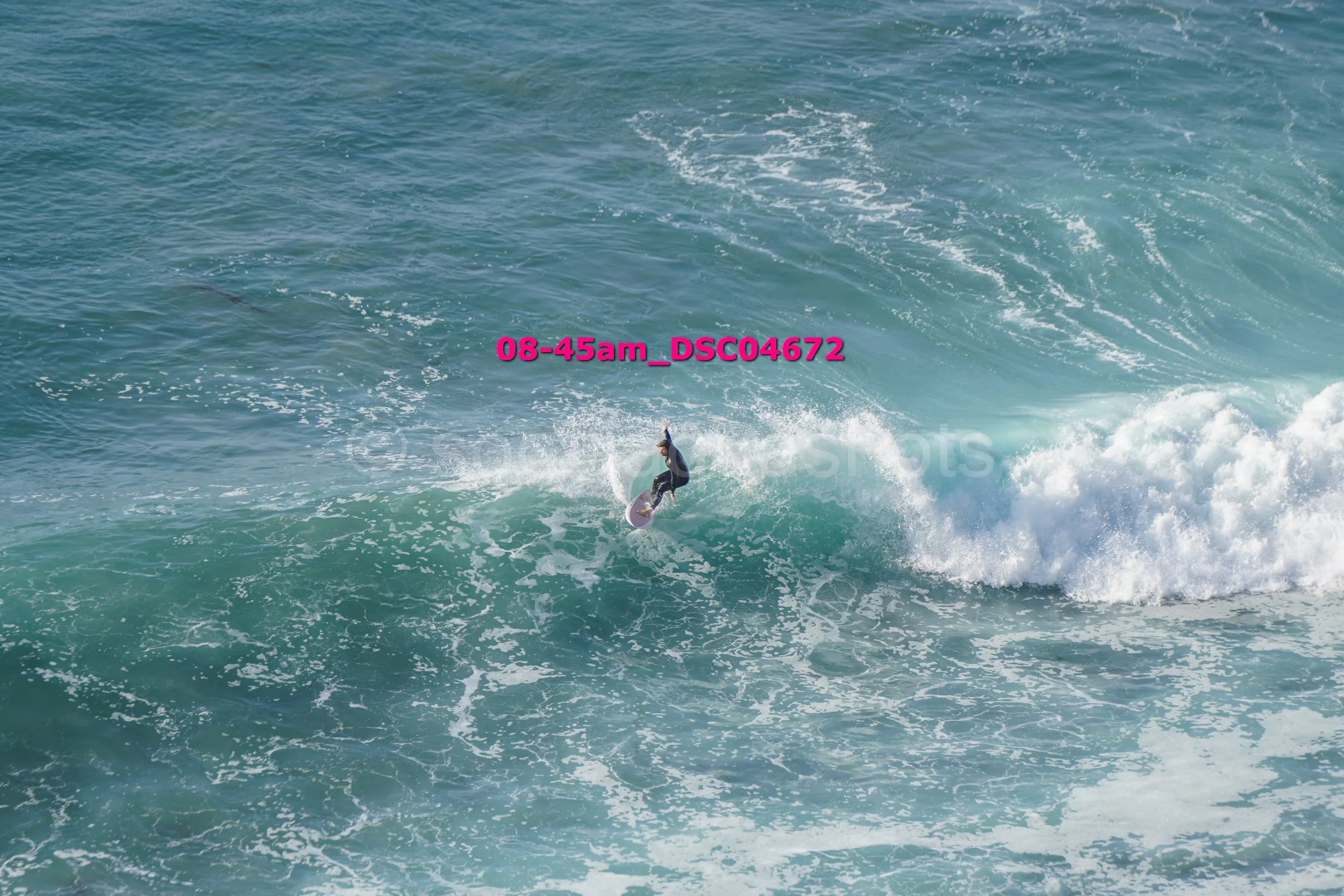 Surfer riding a wave in the ocean.