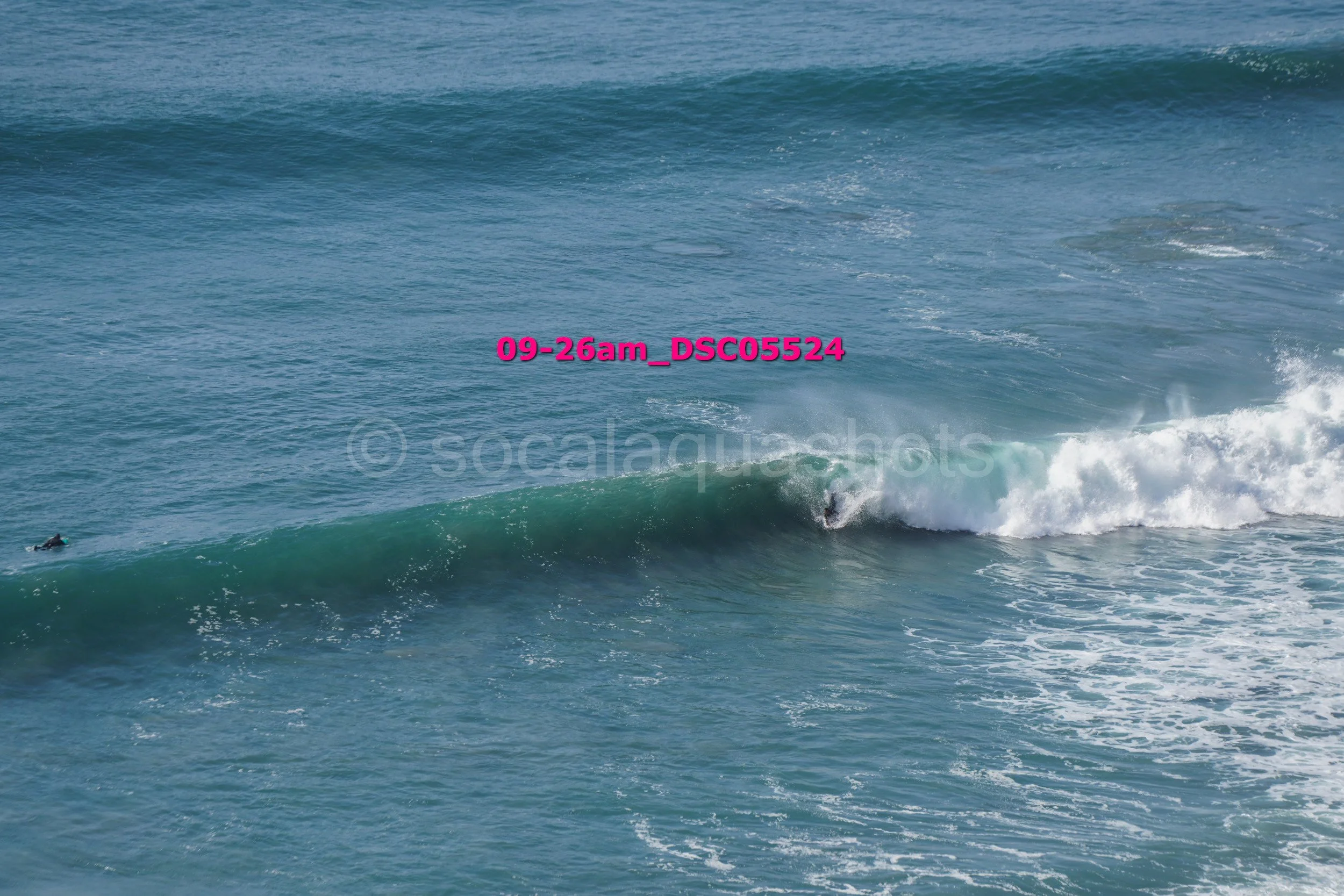 A person surfing on a wave in the ocean.