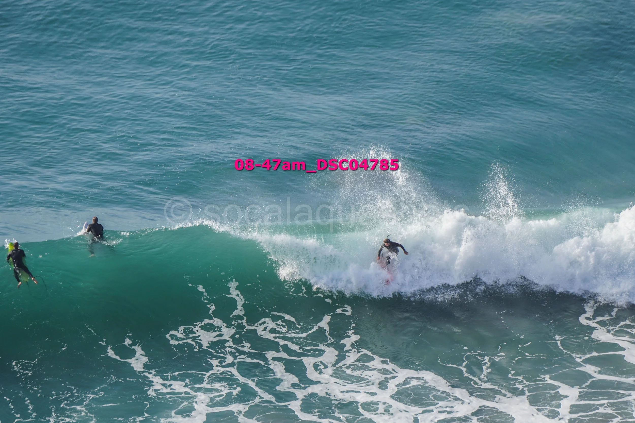 People surfing on ocean waves with clear water and foam