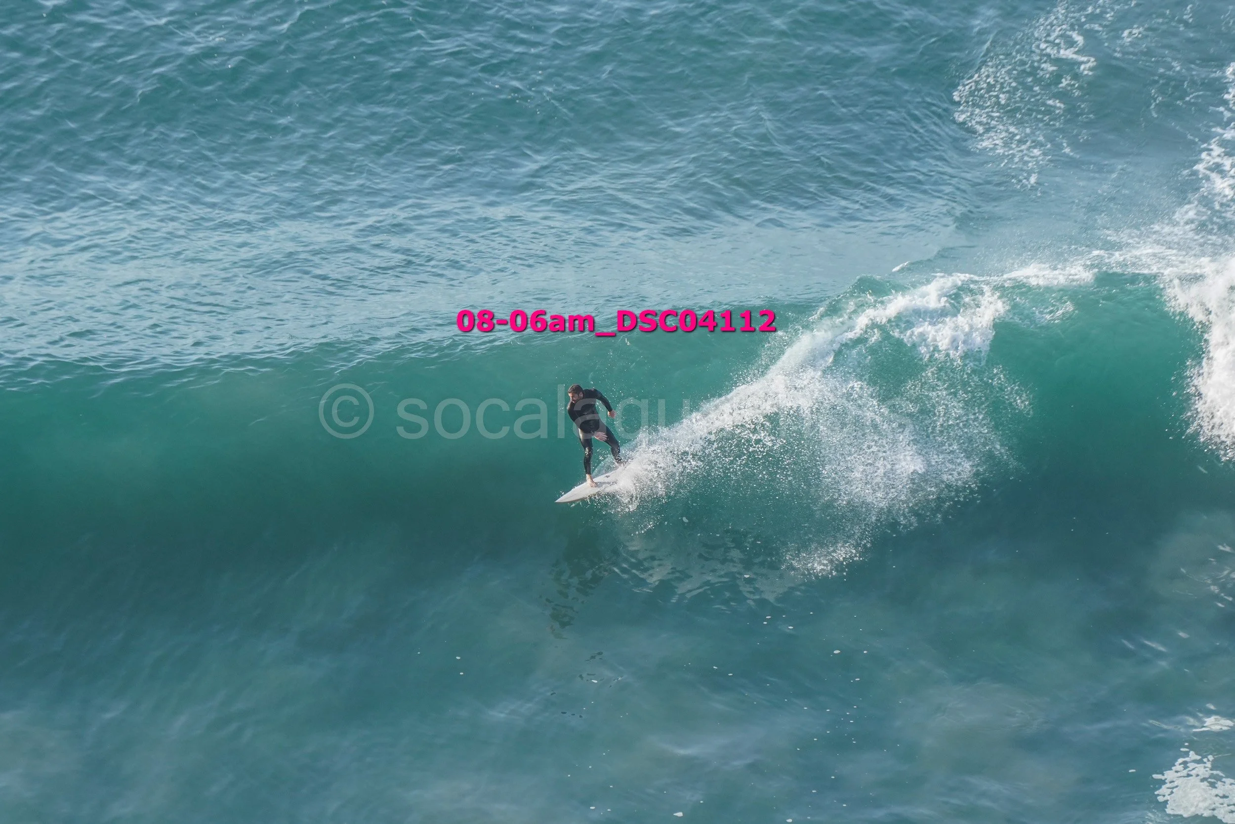 A surfer riding a wave in the ocean during daytime.