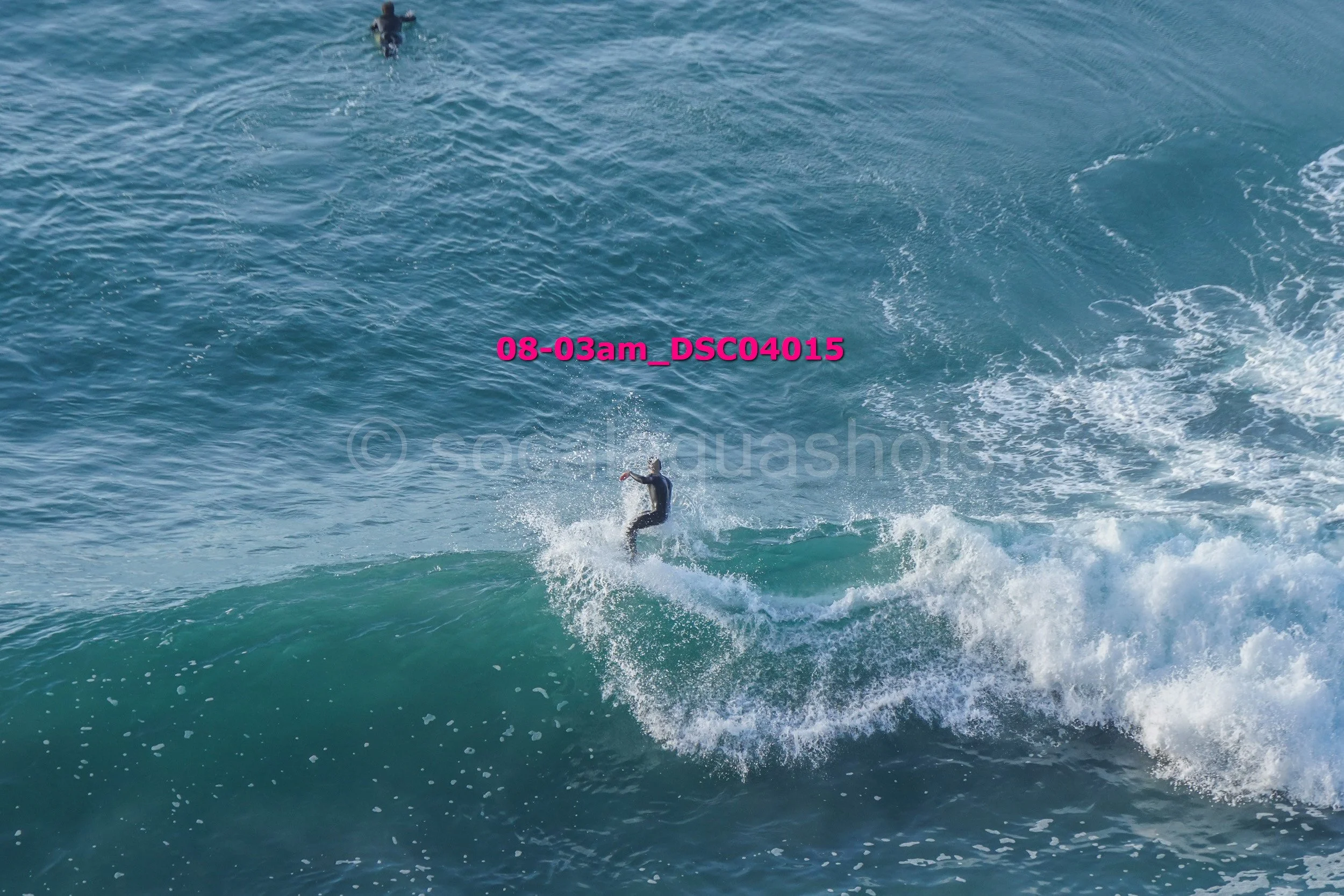A person surfing on a wave in the ocean.