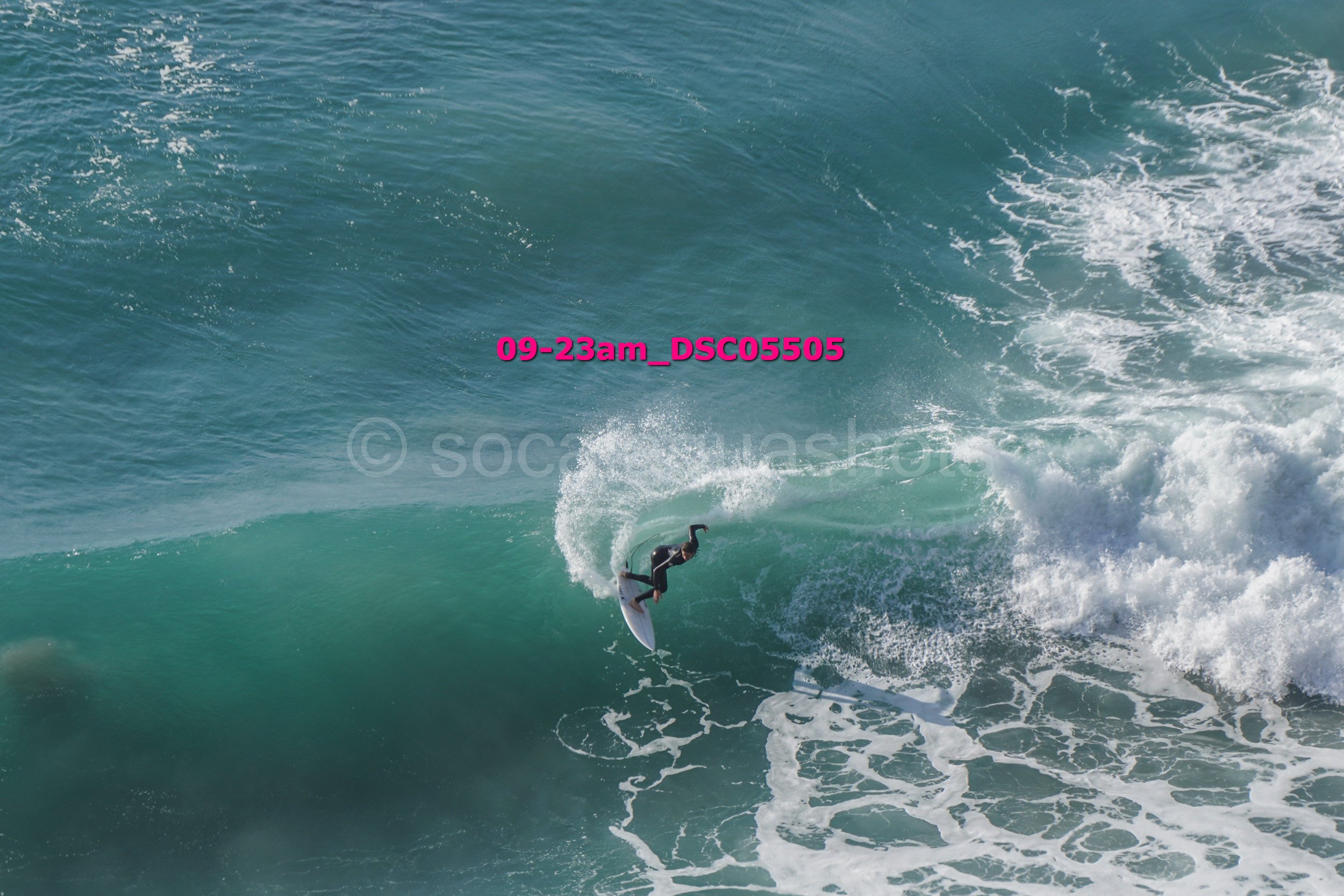 A surfer riding a wave in the ocean.