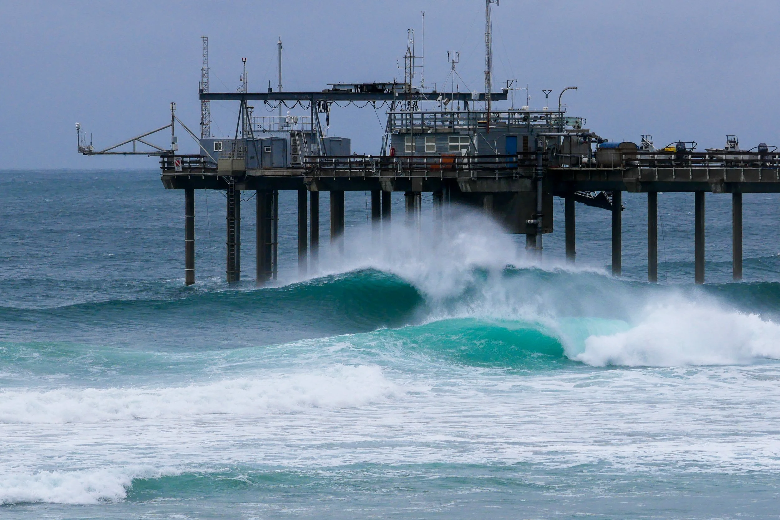 Ocean research pier with waves crashing against it
