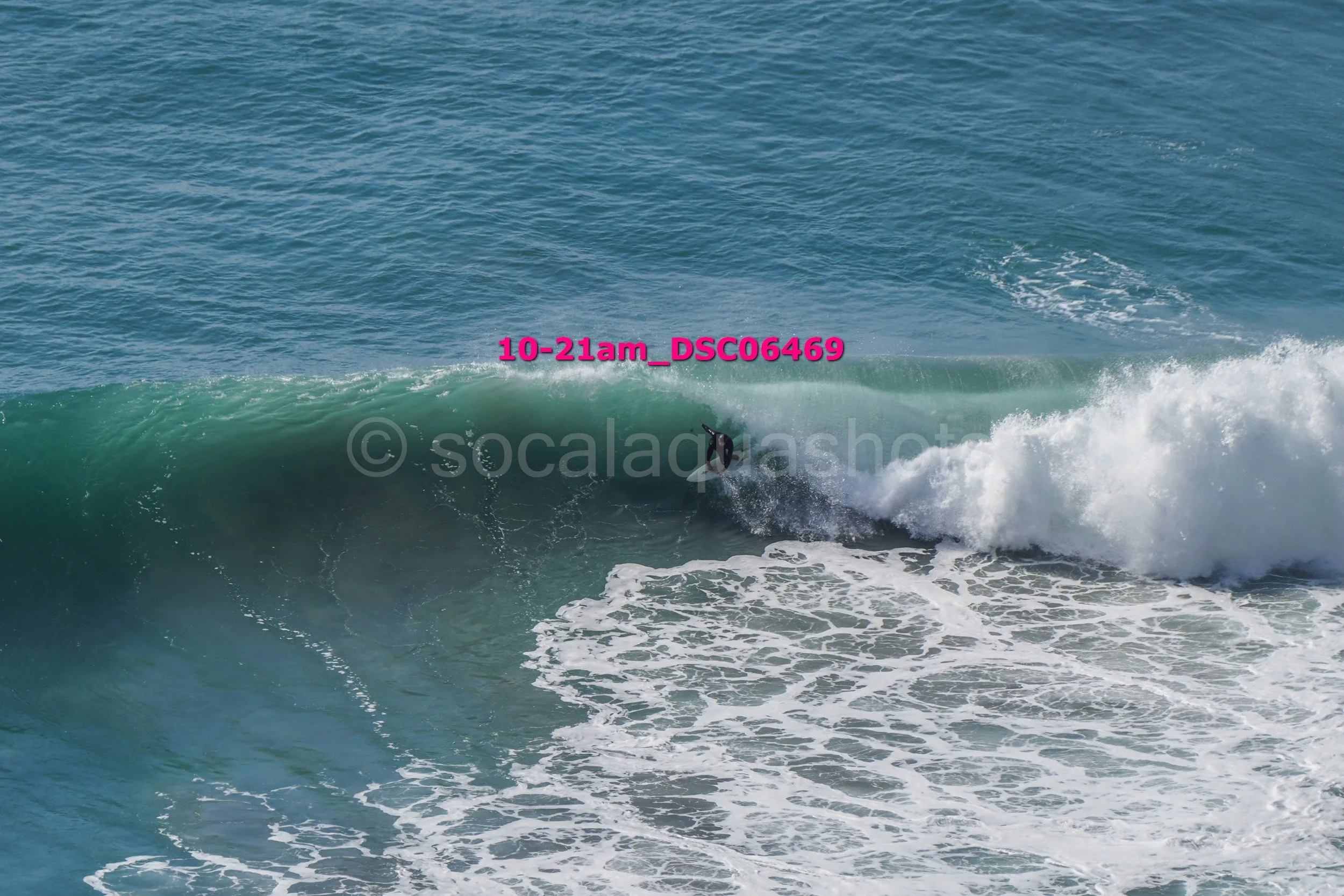 A person surfing on a wave in the ocean.
