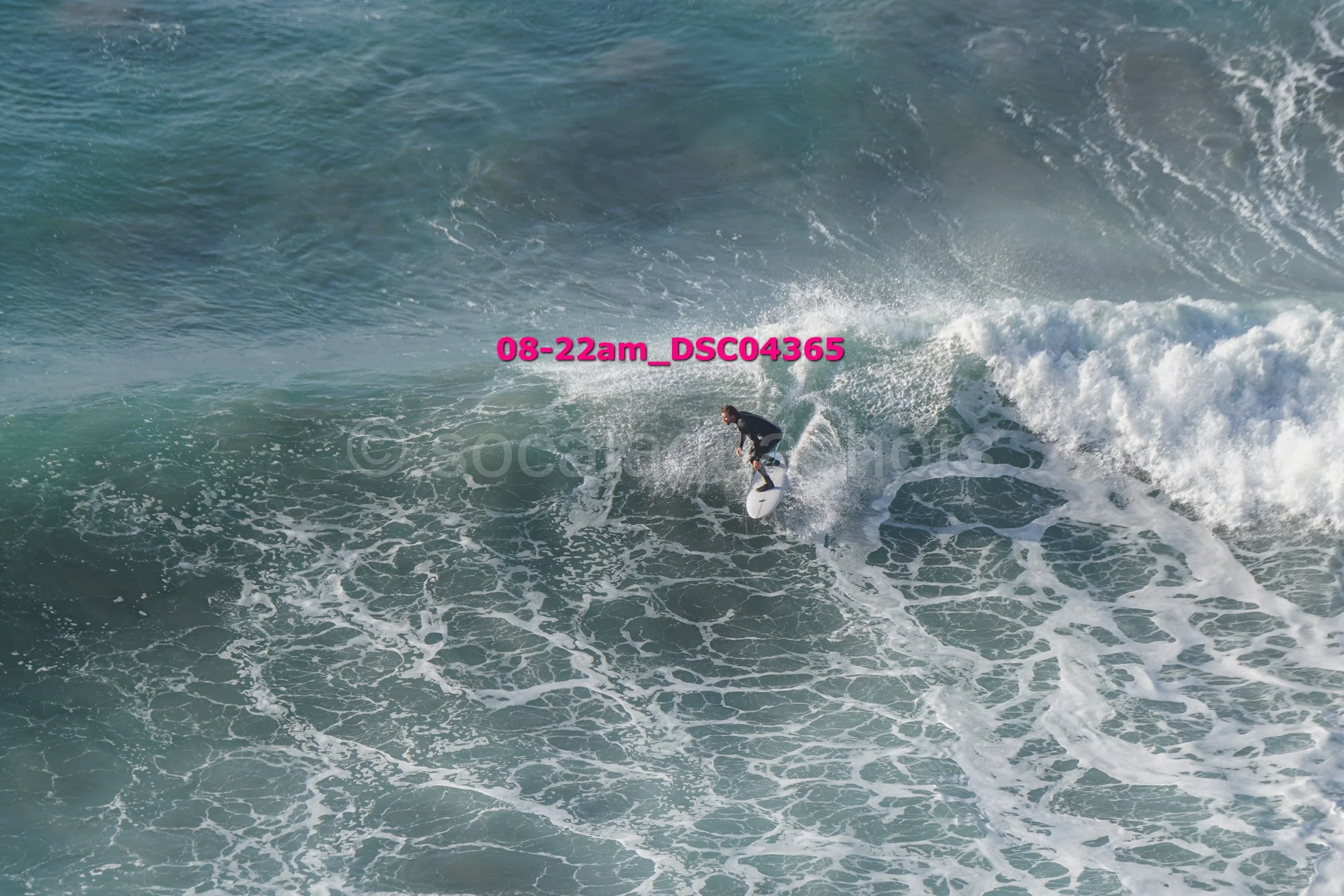 A person surfing on a wave in the ocean.