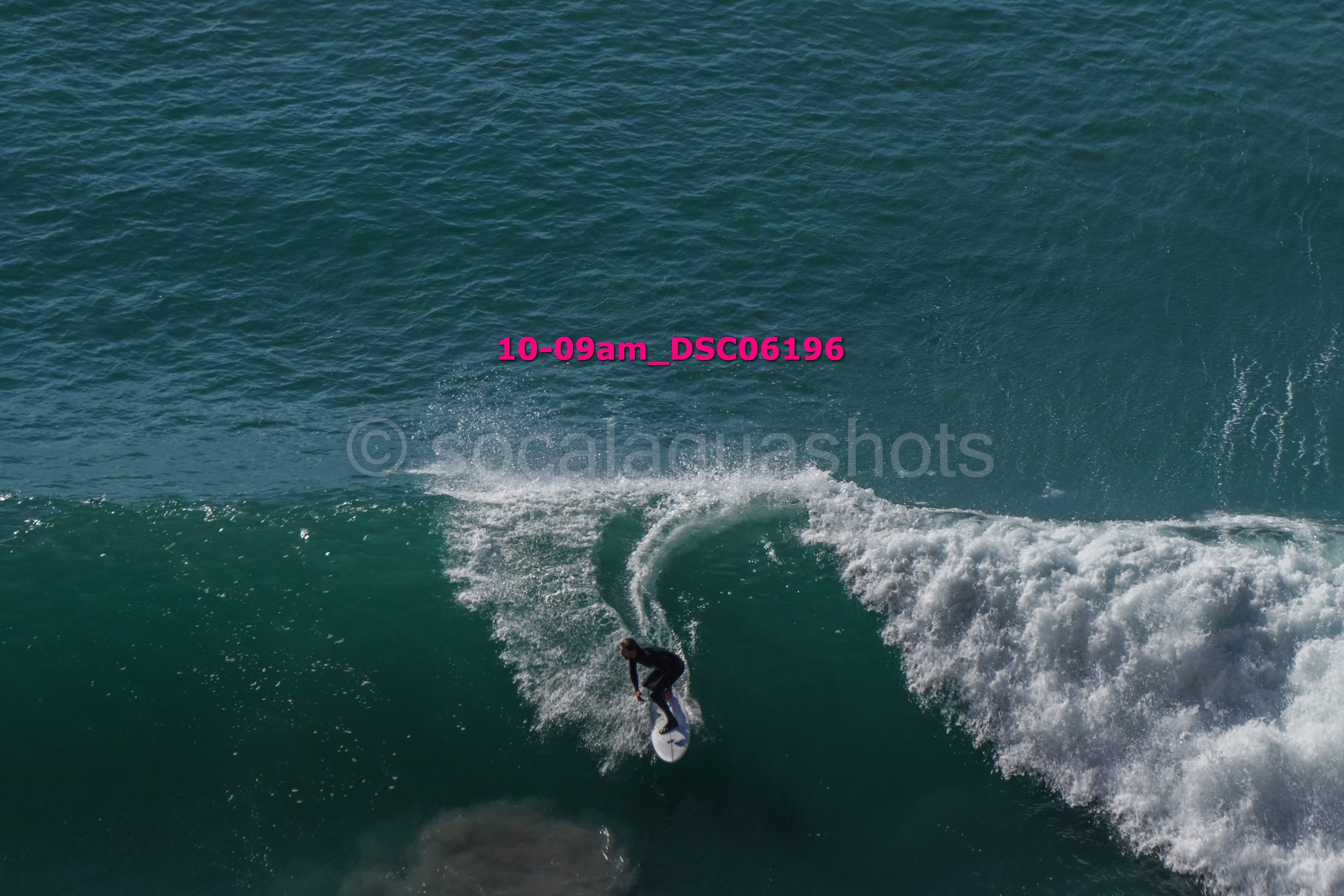 A person surfing on a wave in the ocean.