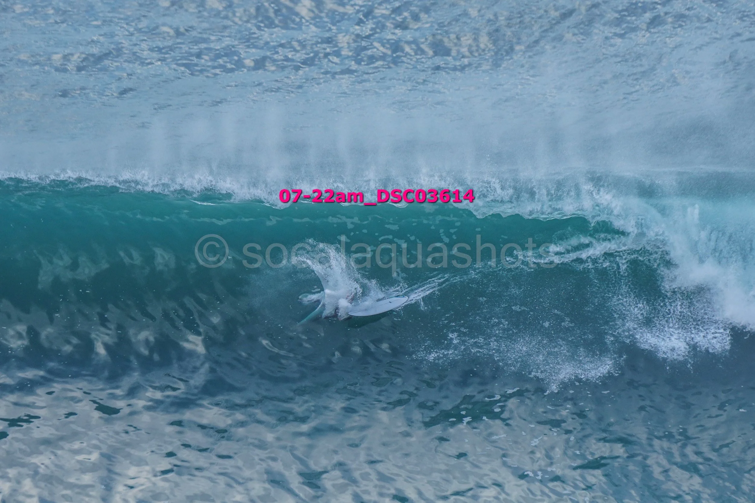 A surfer riding inside the barrel of a large ocean wave on a surfboard.