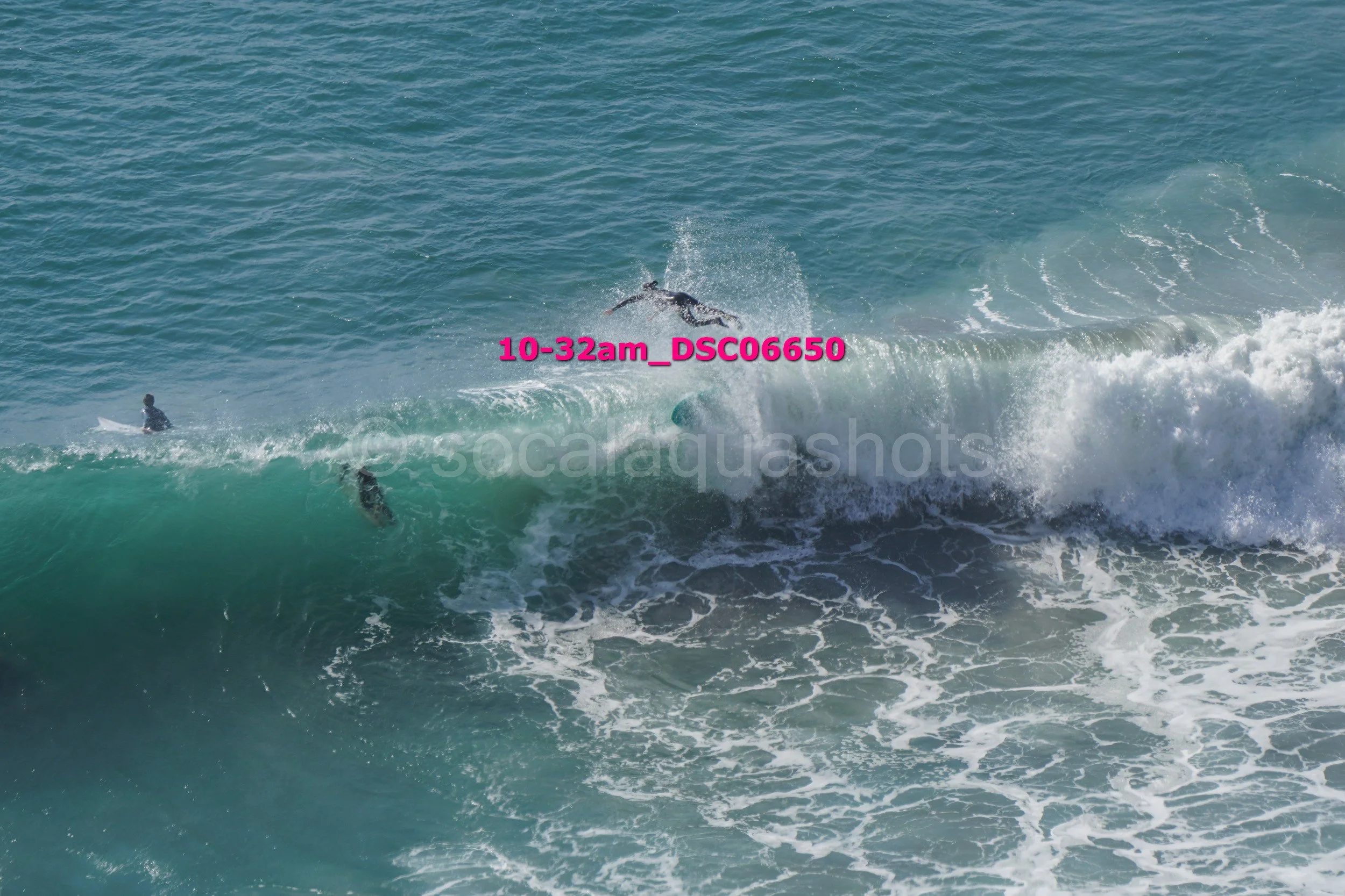 Surfers riding a wave in the ocean