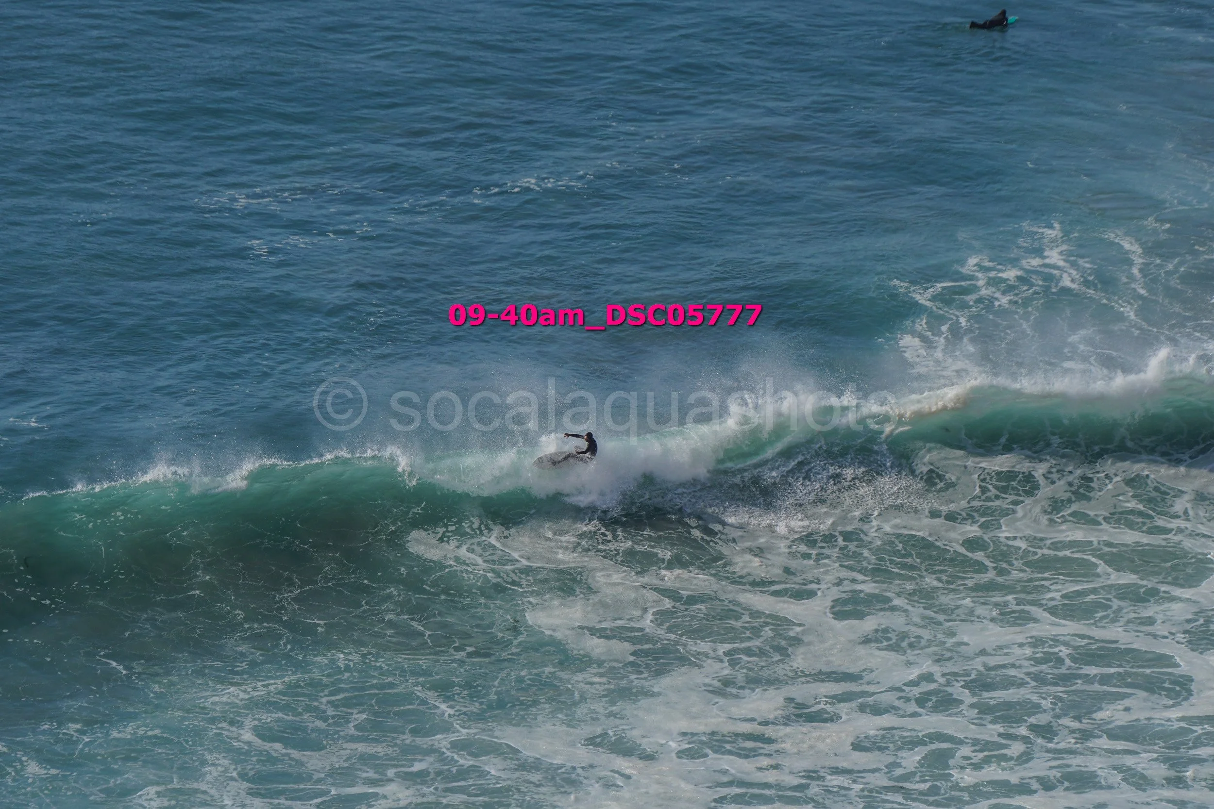 Surfer riding a wave in the ocean with a fish-shaped surfboard.