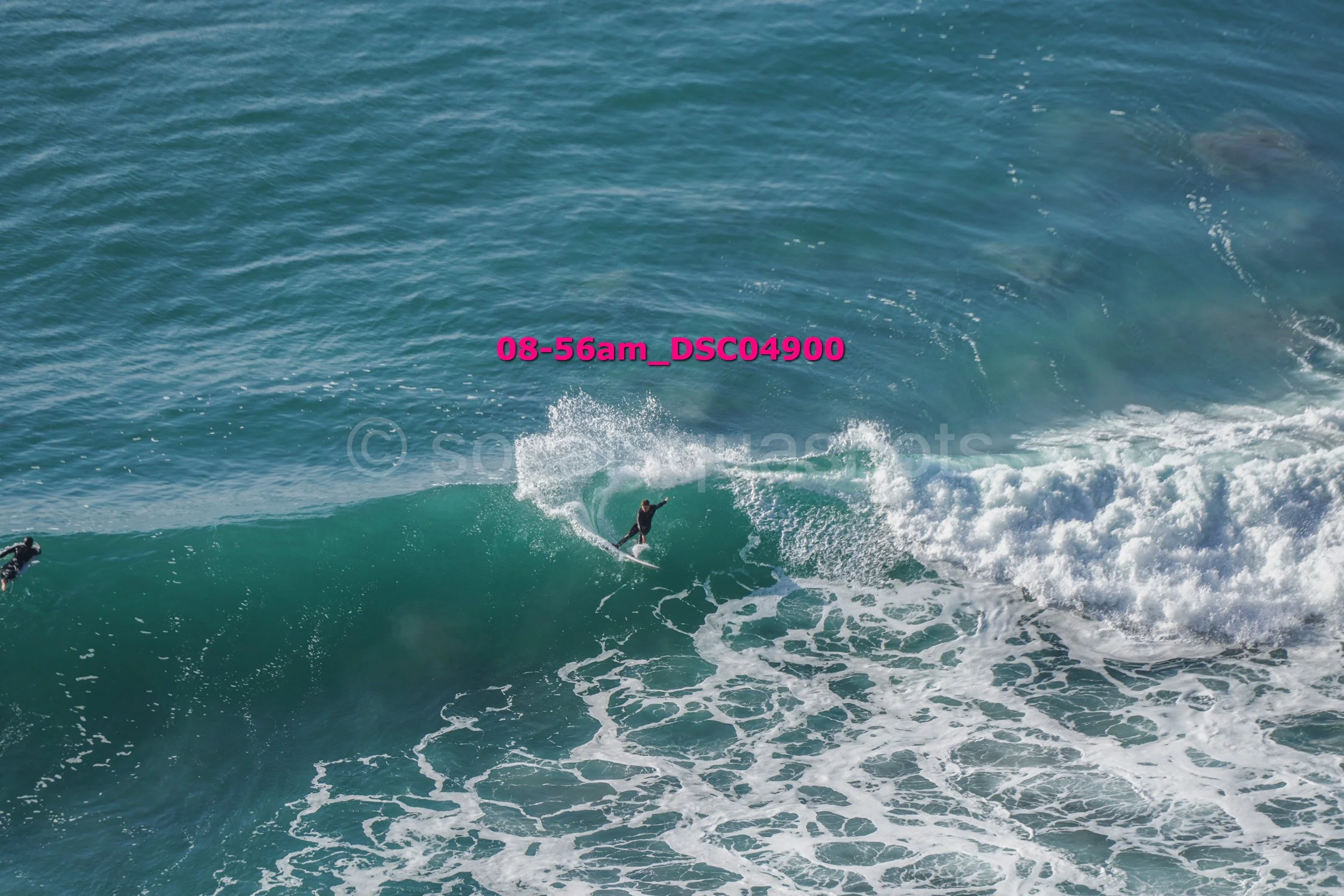 A person surfing on a wave in the ocean during the daytime.