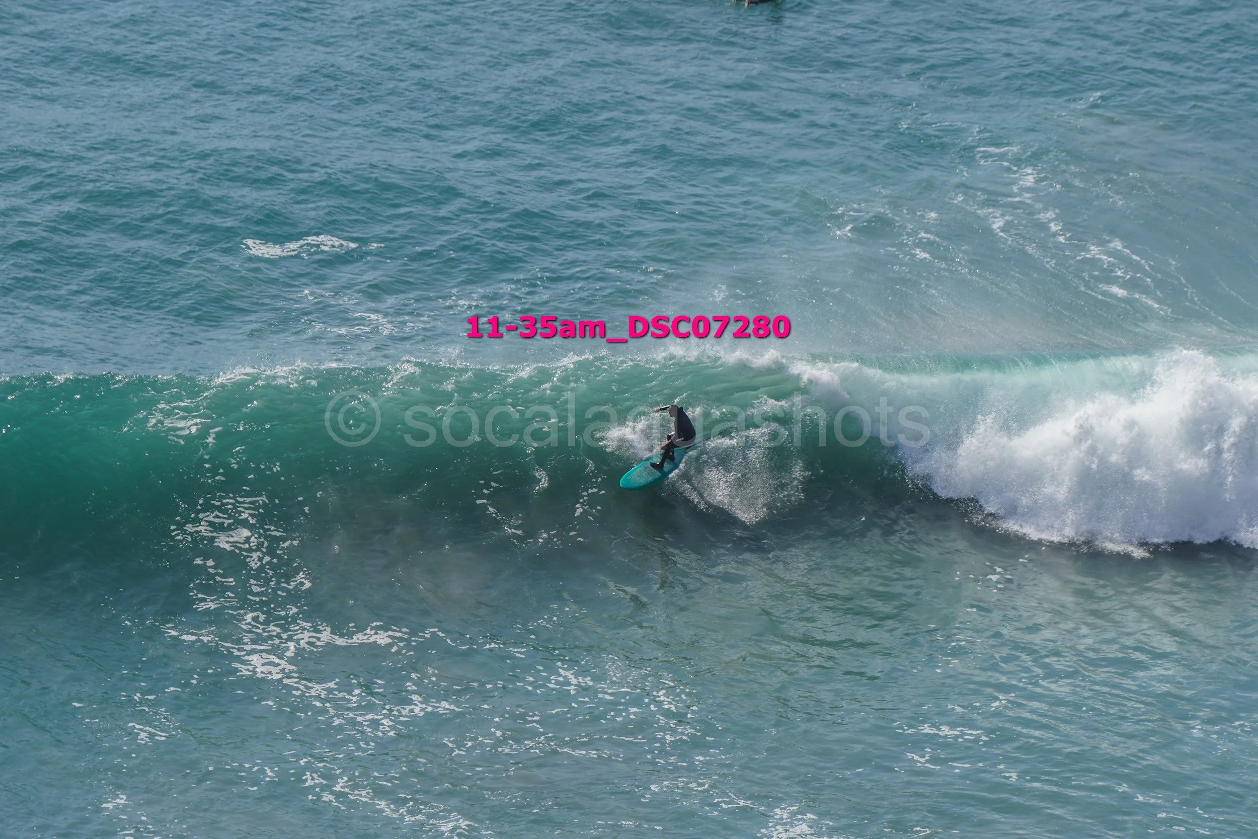 A person surfing on a wave in the ocean.