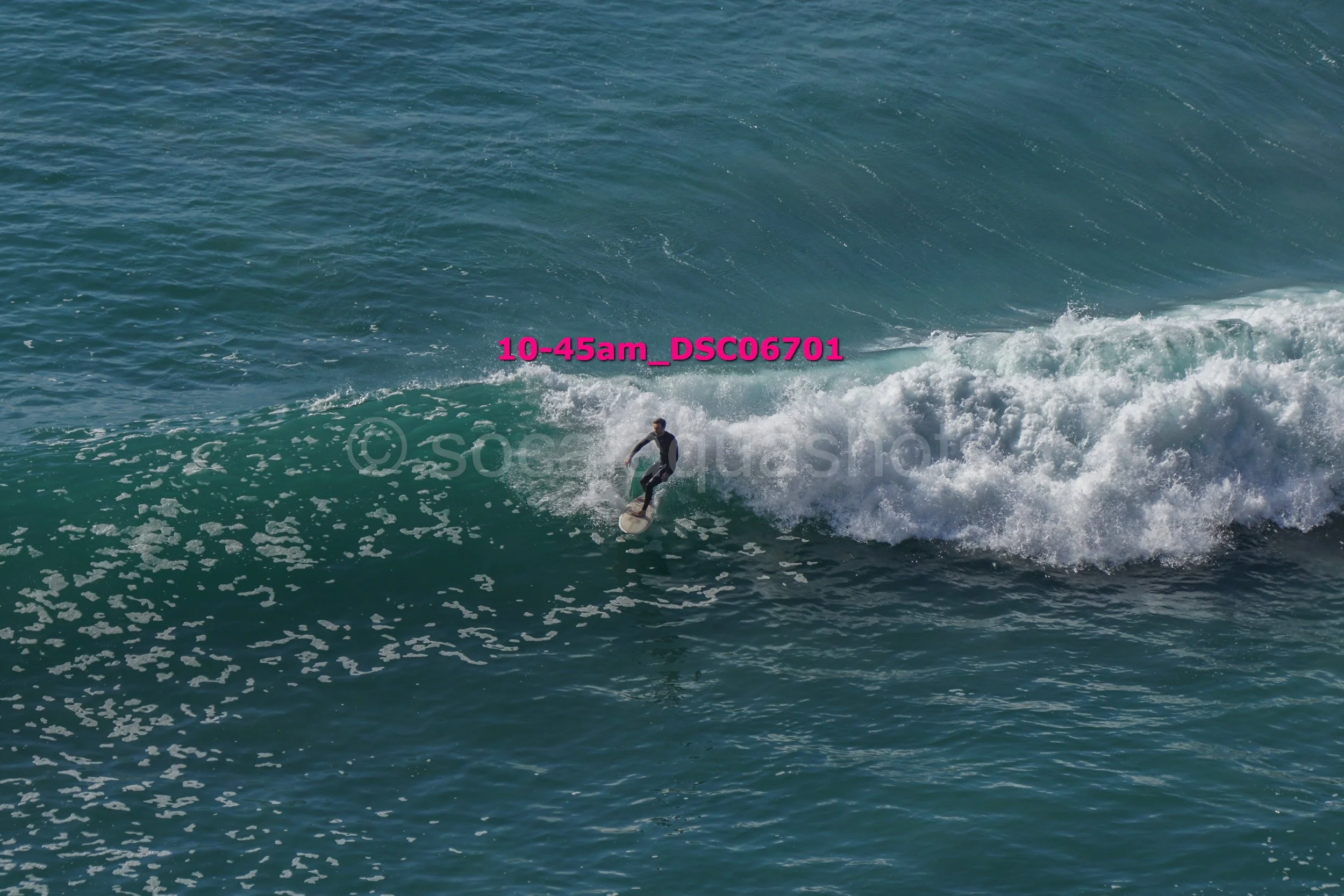 A person surfing on a wave in the ocean during daytime