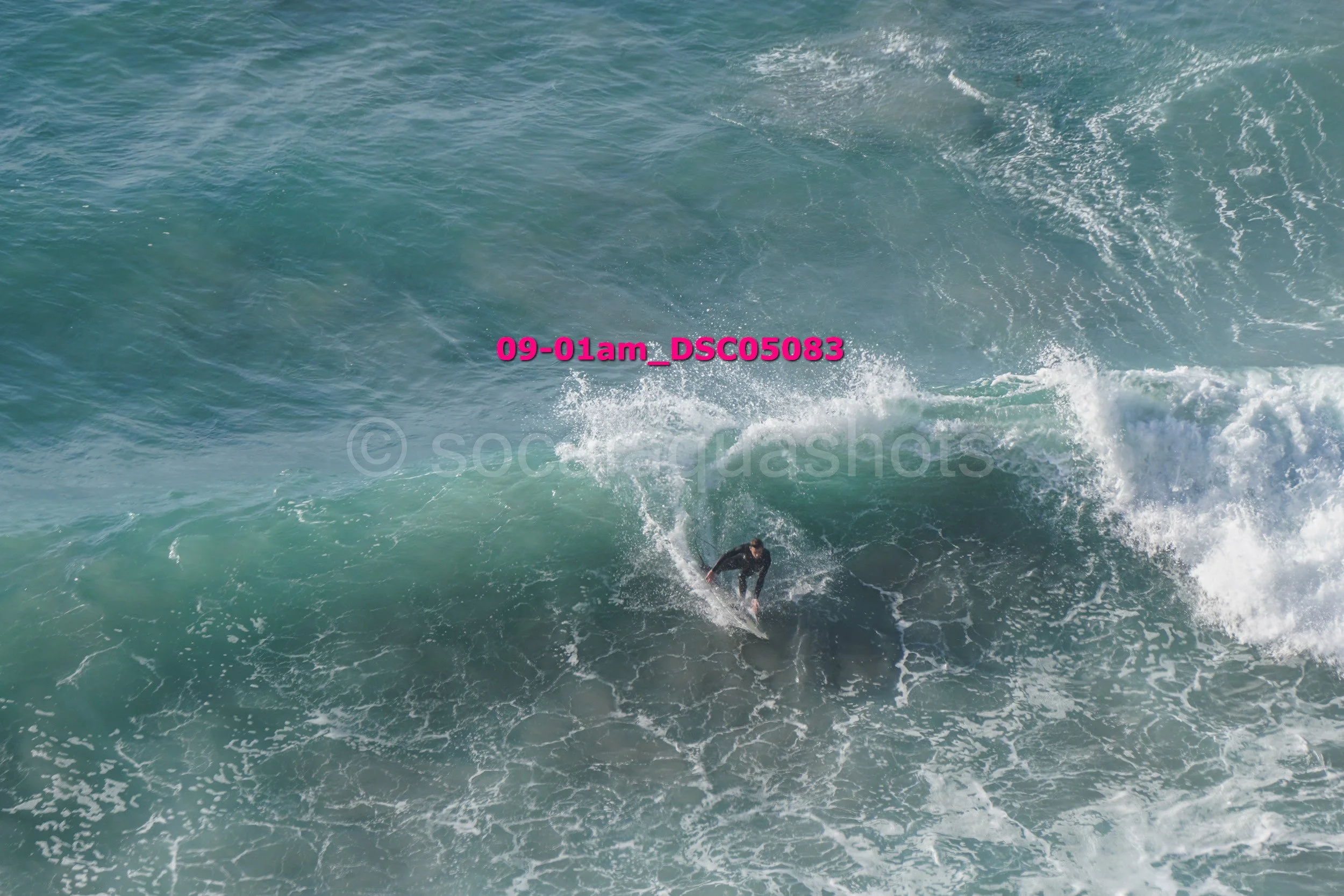 A person surfing on a wave in the ocean.