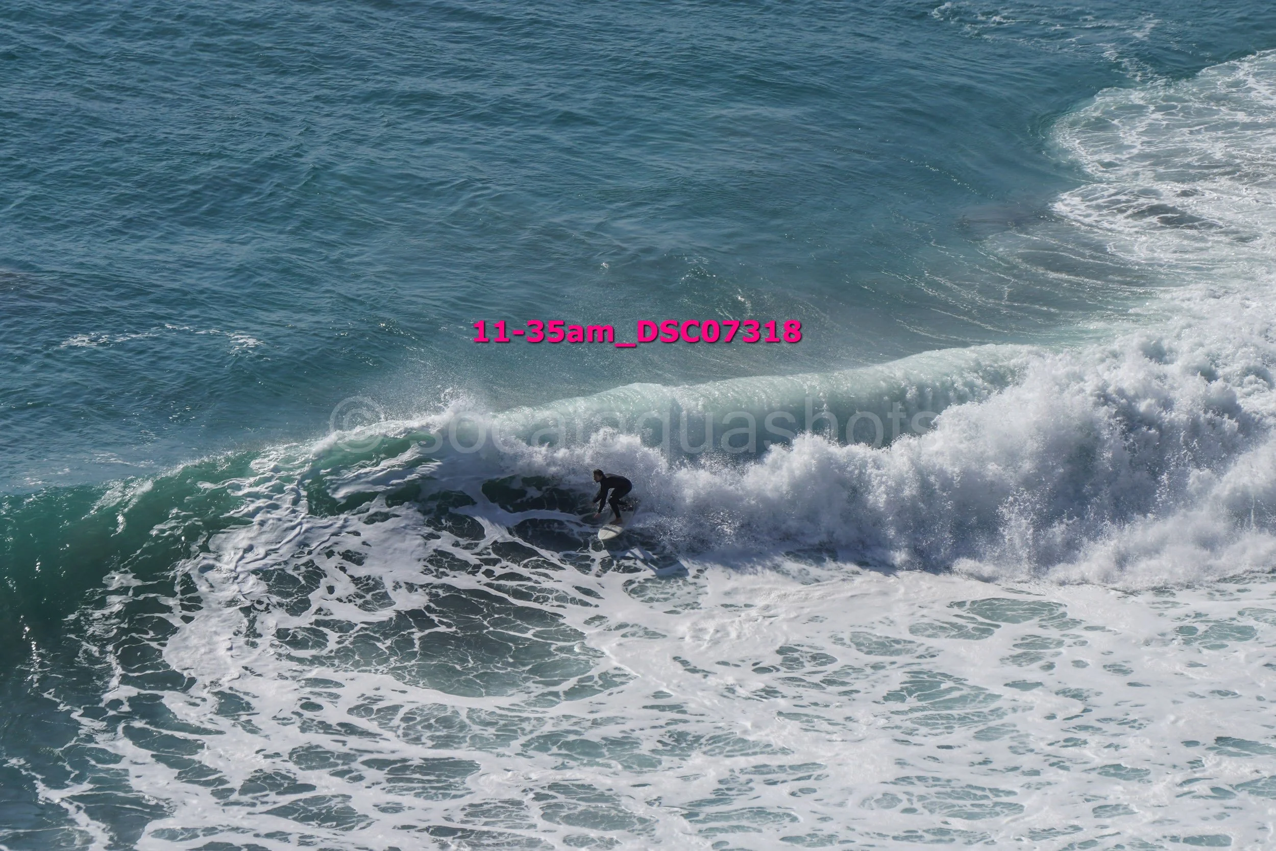 Surfer riding a wave in the ocean.
