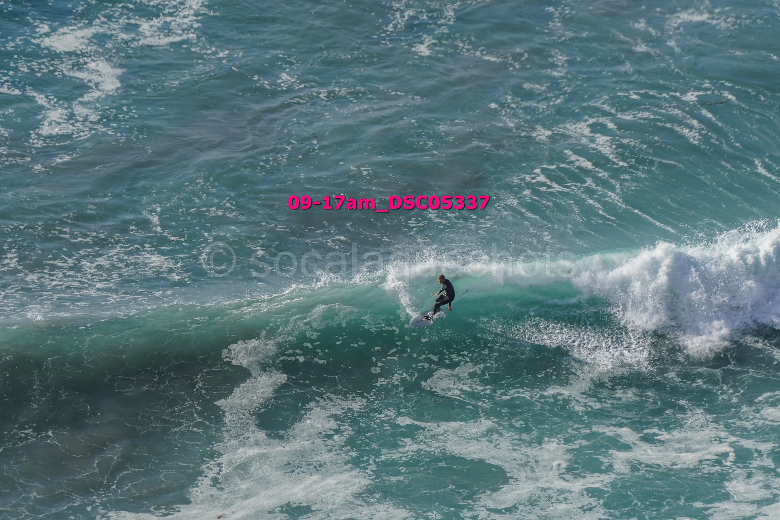 A person surfing on a wave in the ocean.
