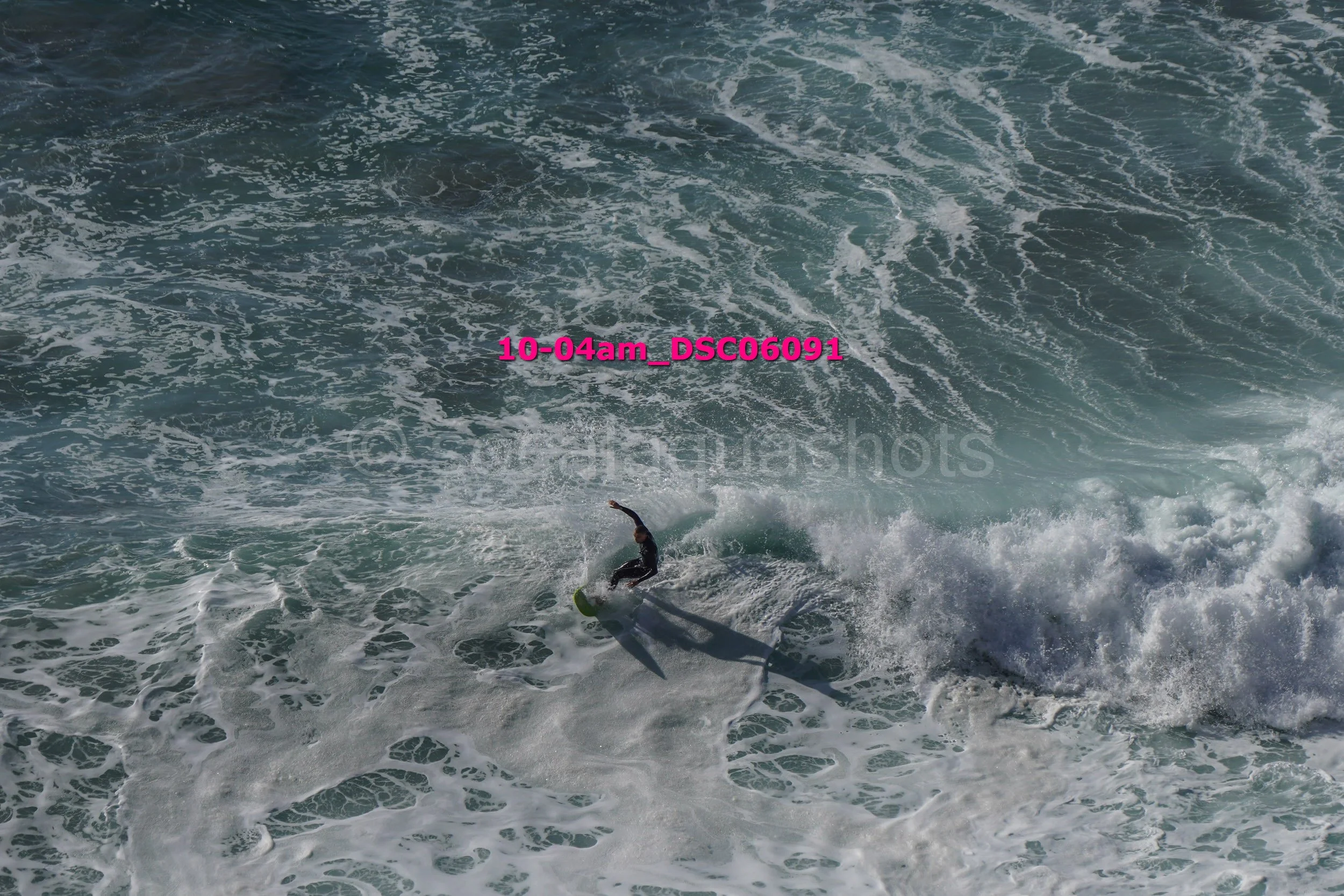 A person surfing on a wave in the ocean during daytime.
