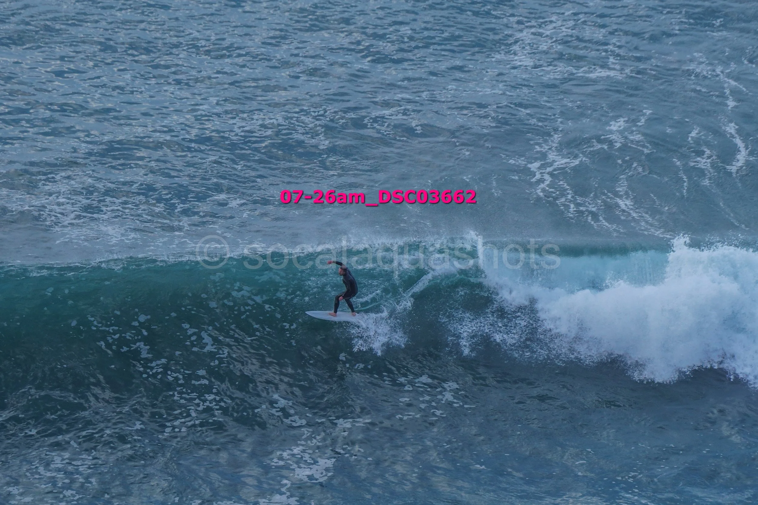 A person surfing on a wave in the ocean.