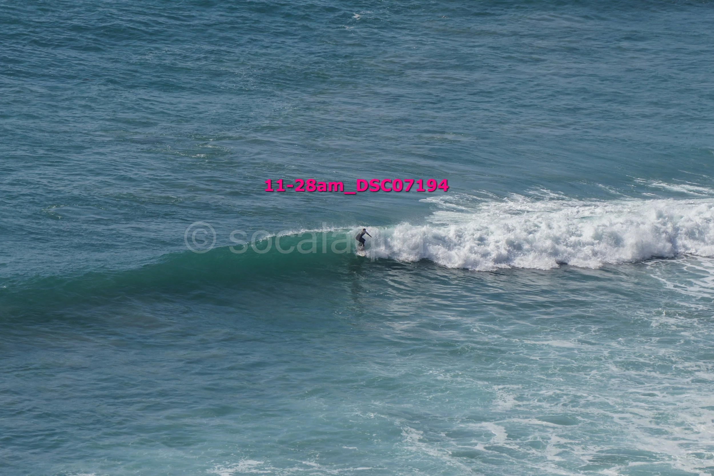 A person surfing on a wave in the ocean.