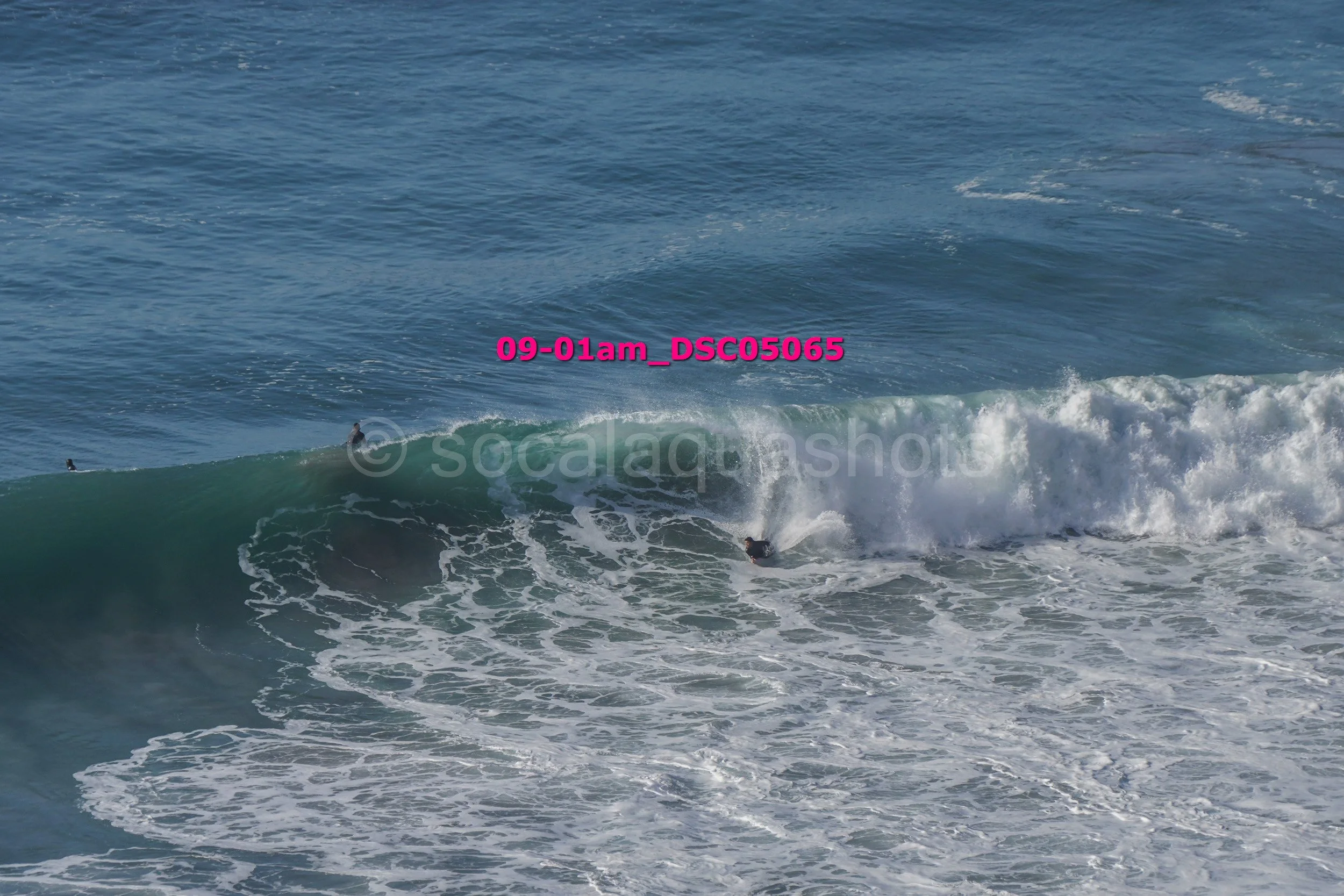 A person surfing a wave in the ocean near the shore.