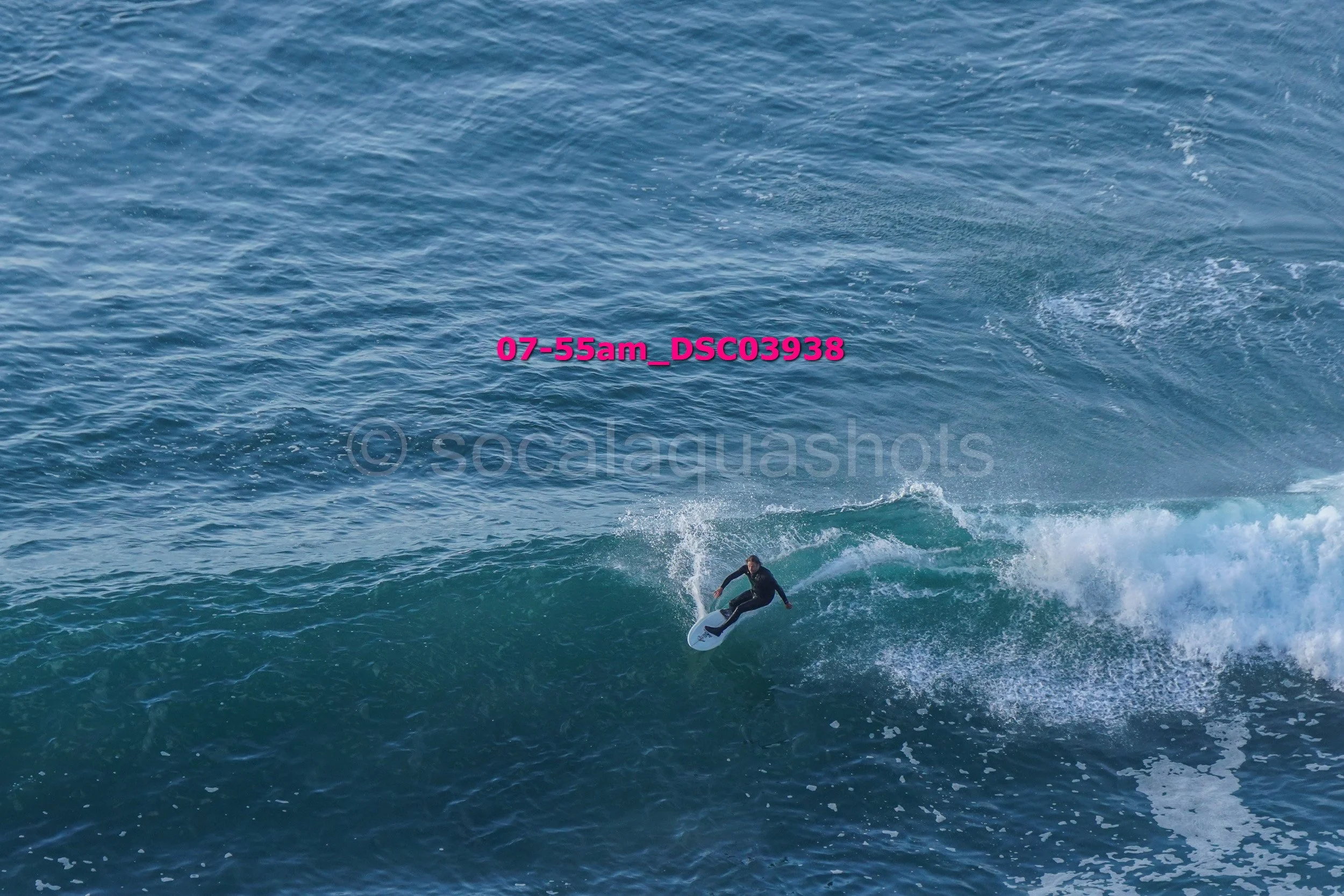 A person surfing on a wave in the ocean with water splashing around.