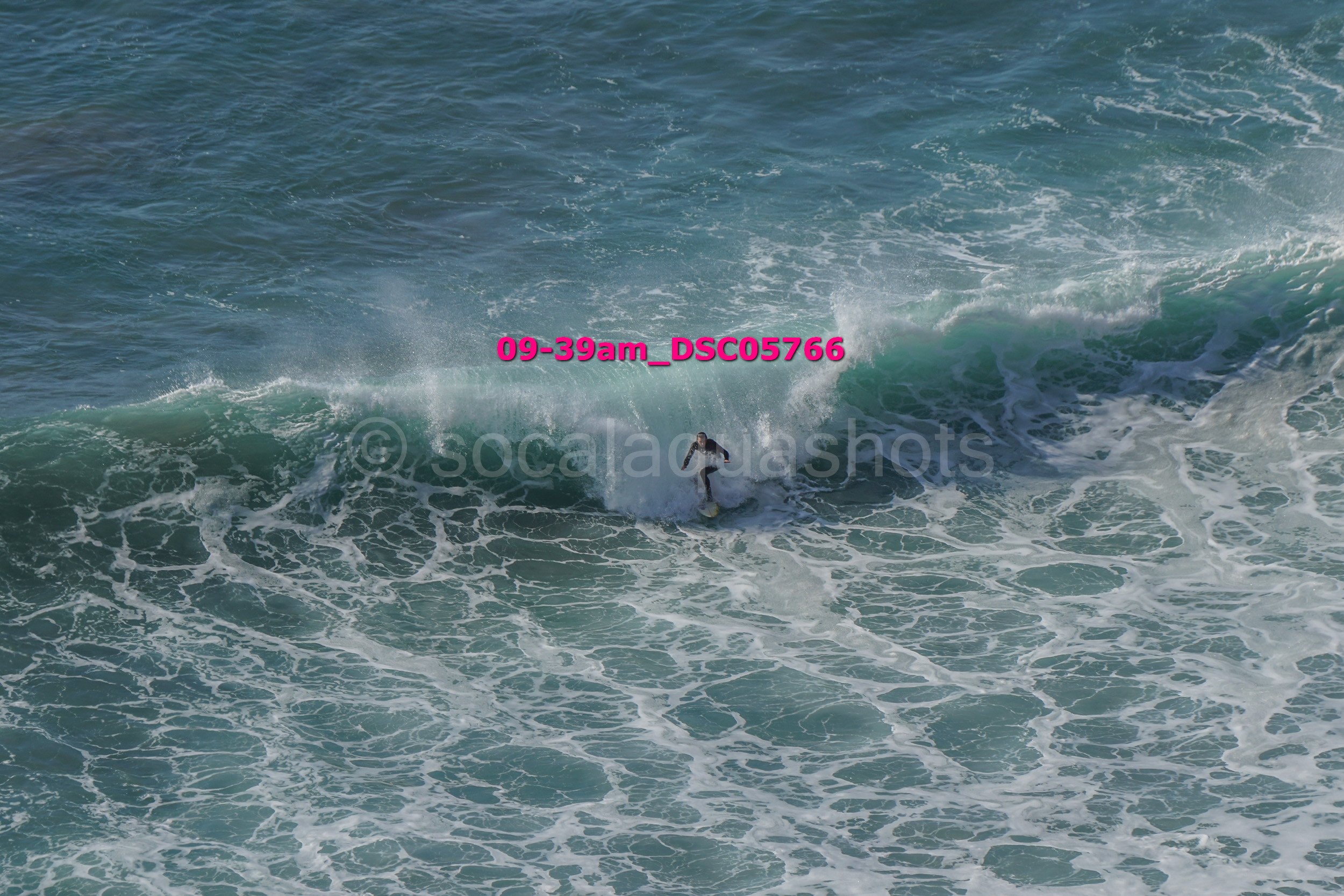 A person surfing on a wave in the ocean.