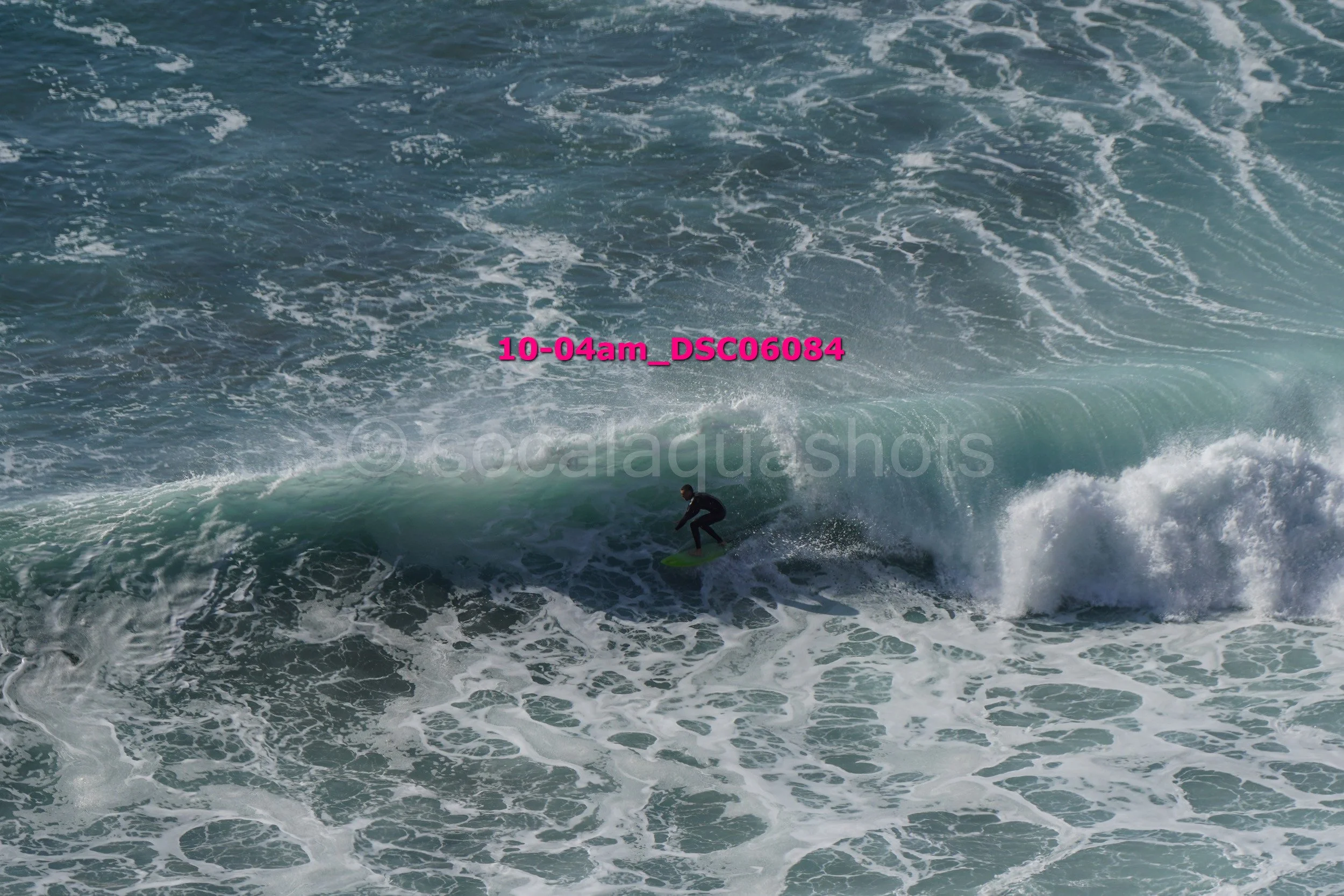 A person surfing on a wave in the ocean.