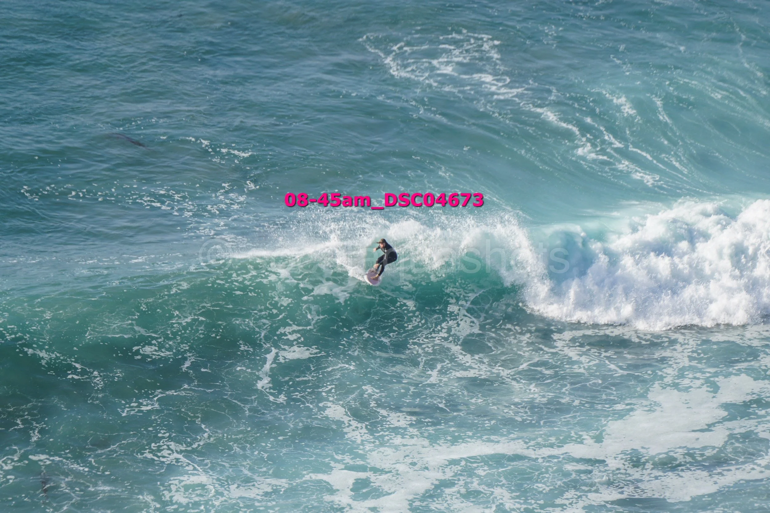 A person surfing on a wave in the ocean