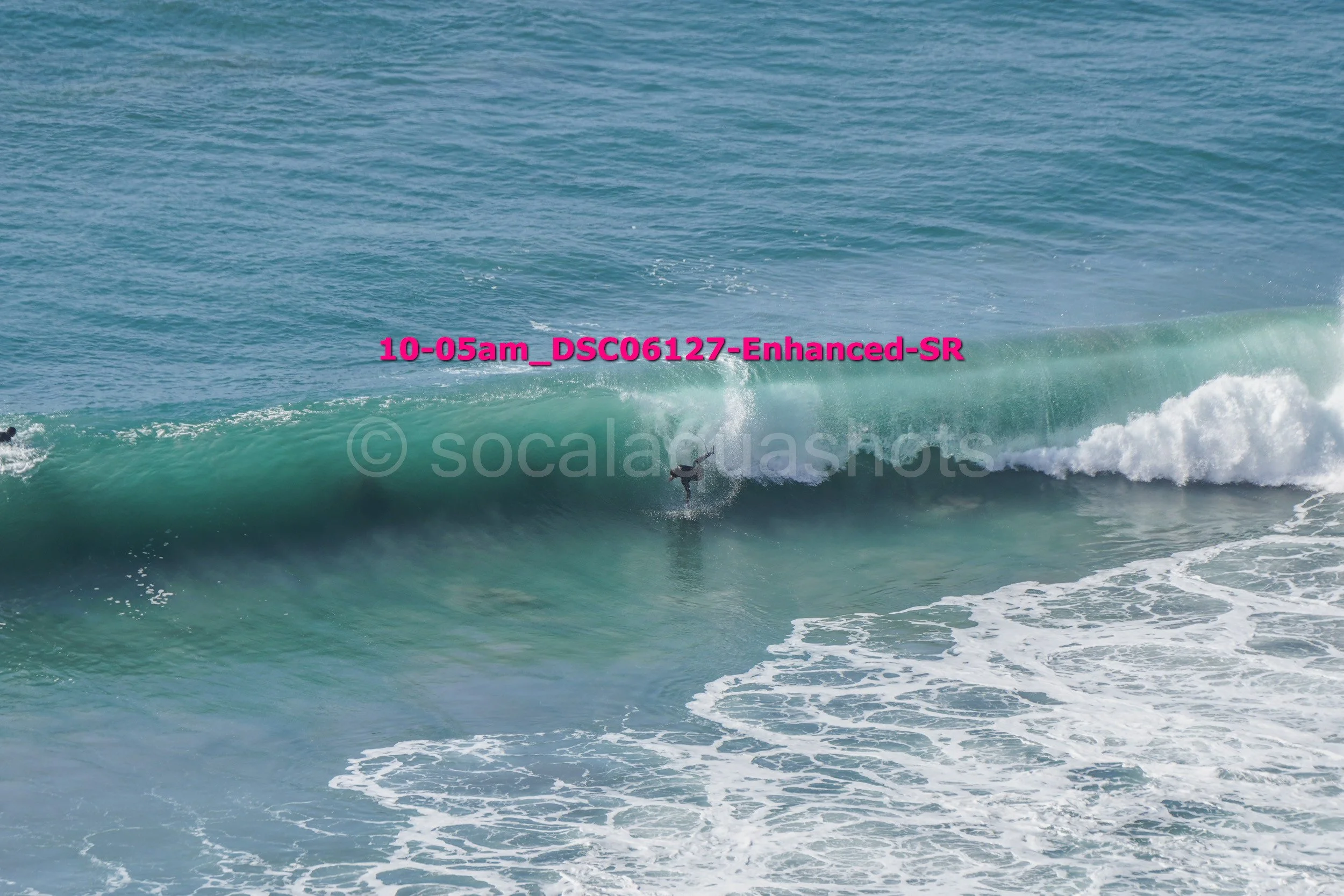 A surfer riding a large ocean wave
