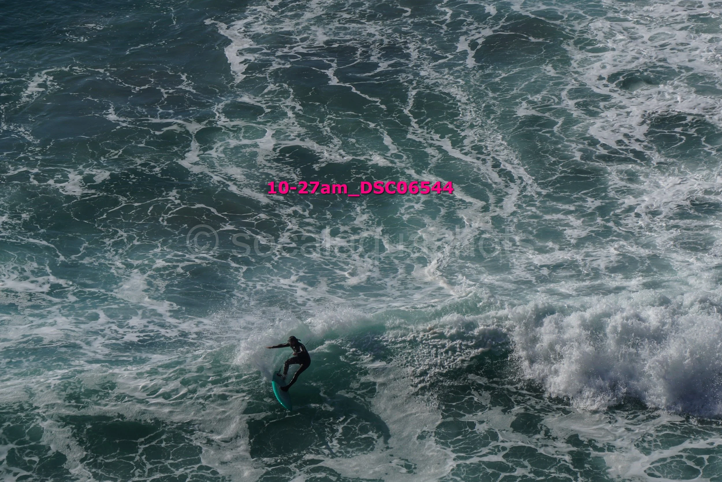 A person surfing on a wave in the ocean.