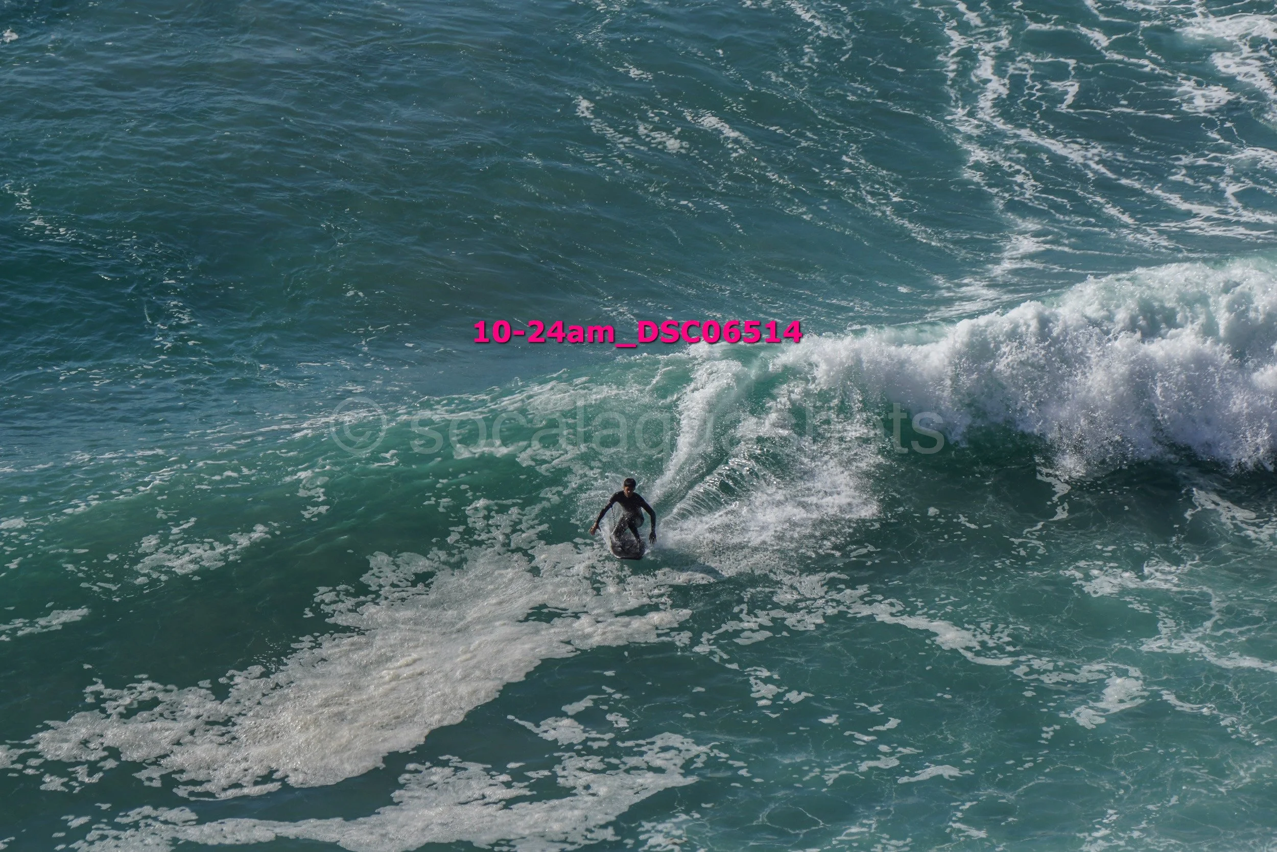 A person surfing on a wave in the ocean.