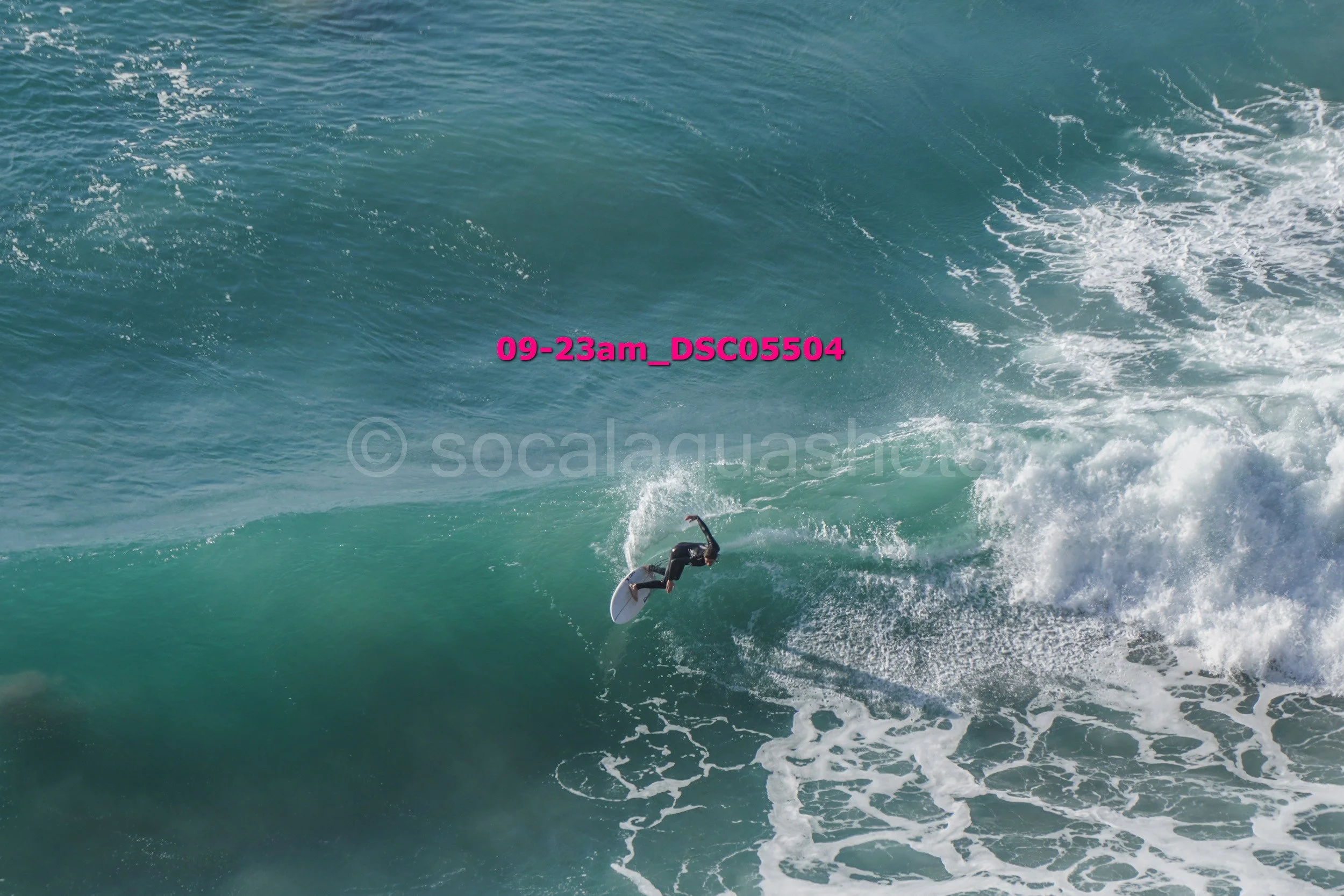 Surfer performing a turn on a large ocean wave.