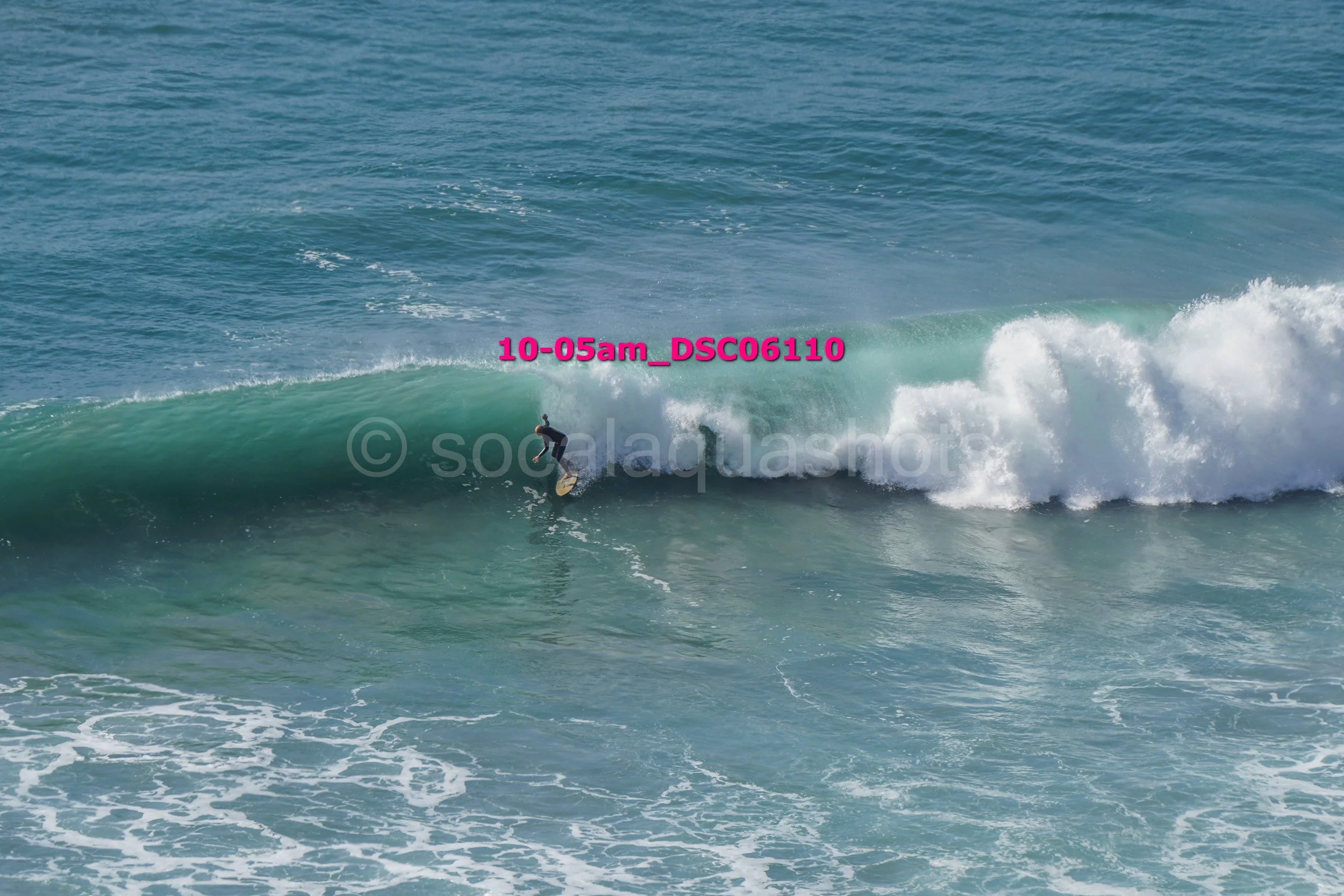 A person surfing on a wave in the ocean.