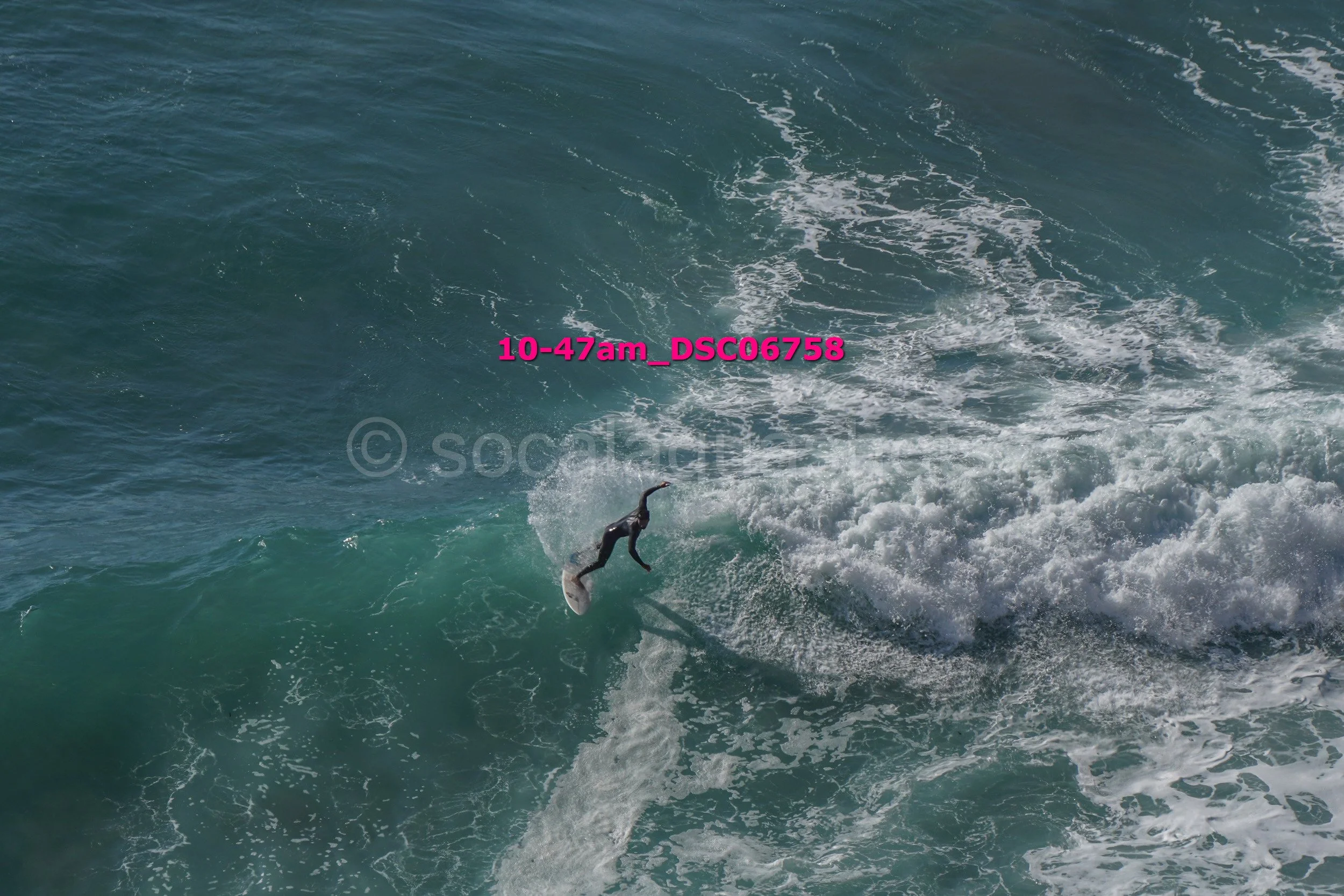 A person surfing on a wave in the ocean.