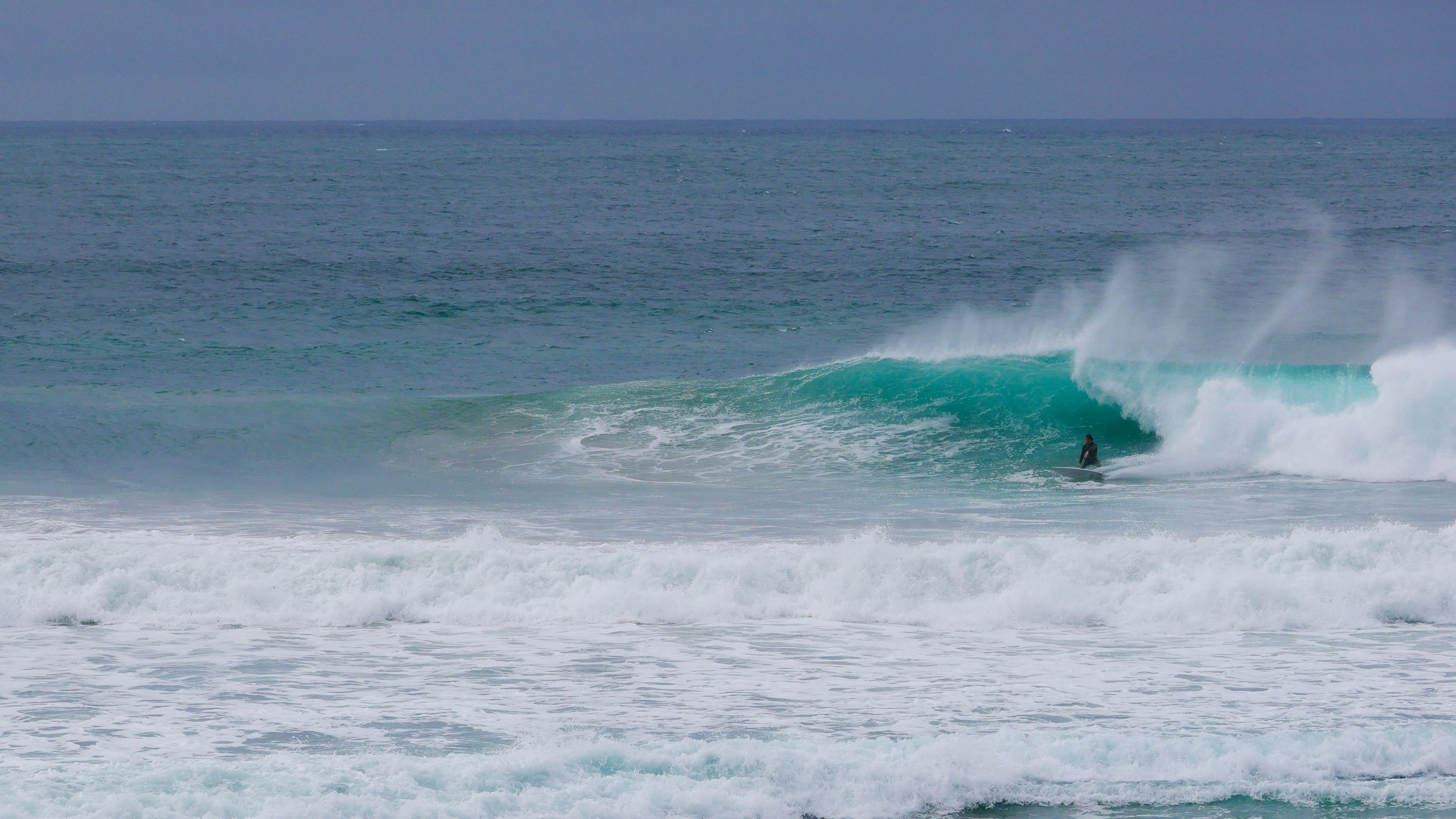 Surfer riding a wave in the ocean