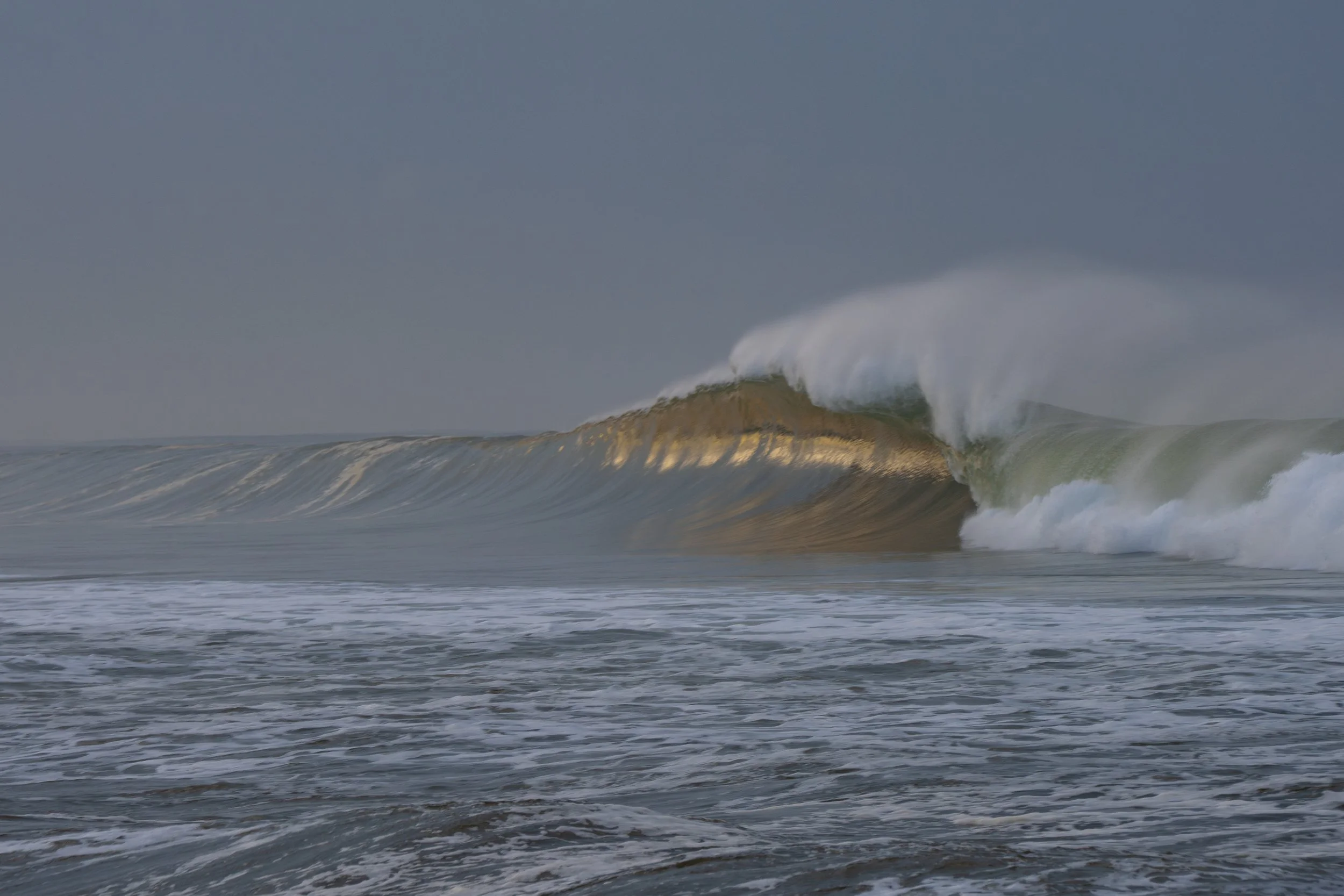 Ocean waves rolling and crashing in the sea on a cloudy day