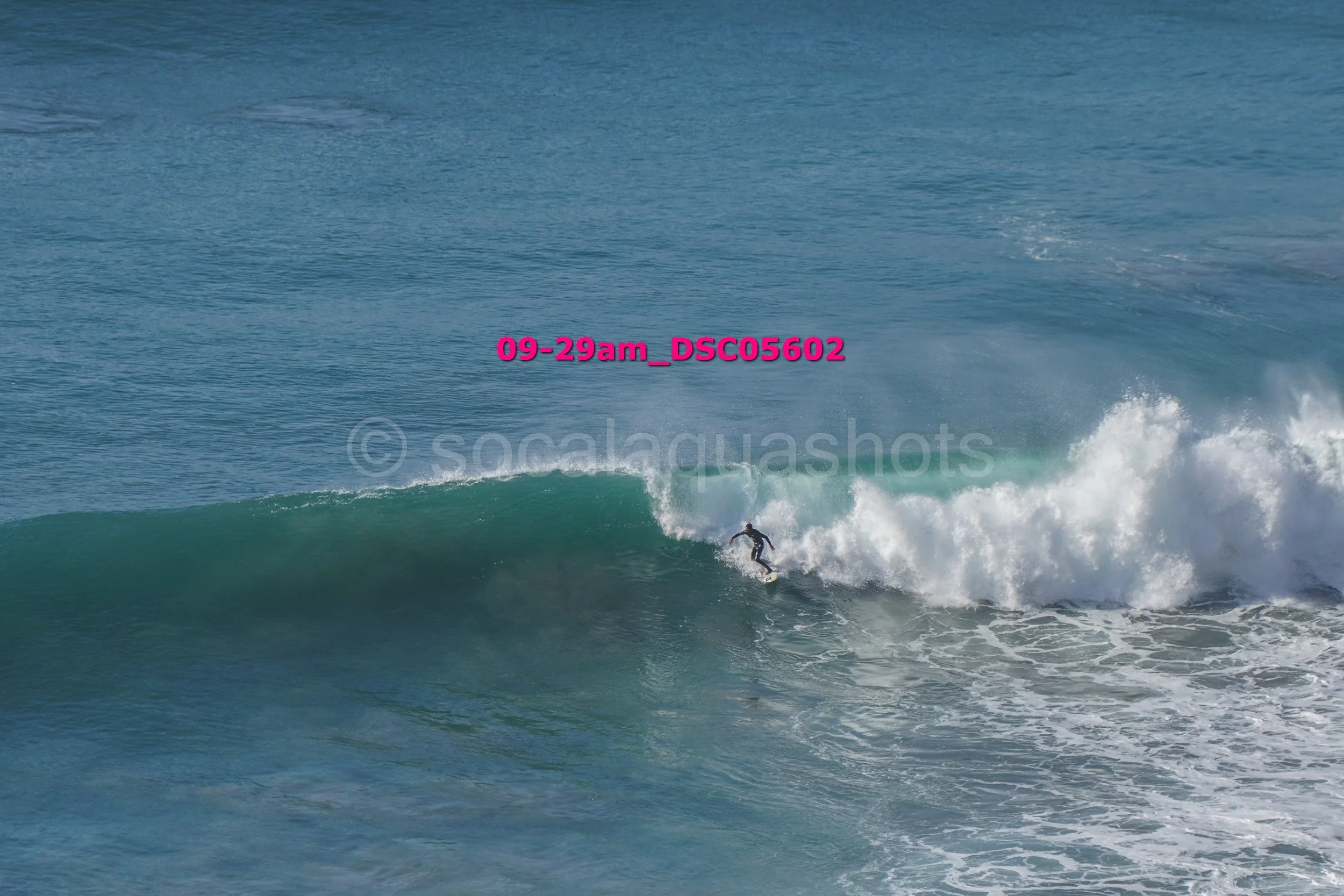 A person surfing on a wave in the ocean.
