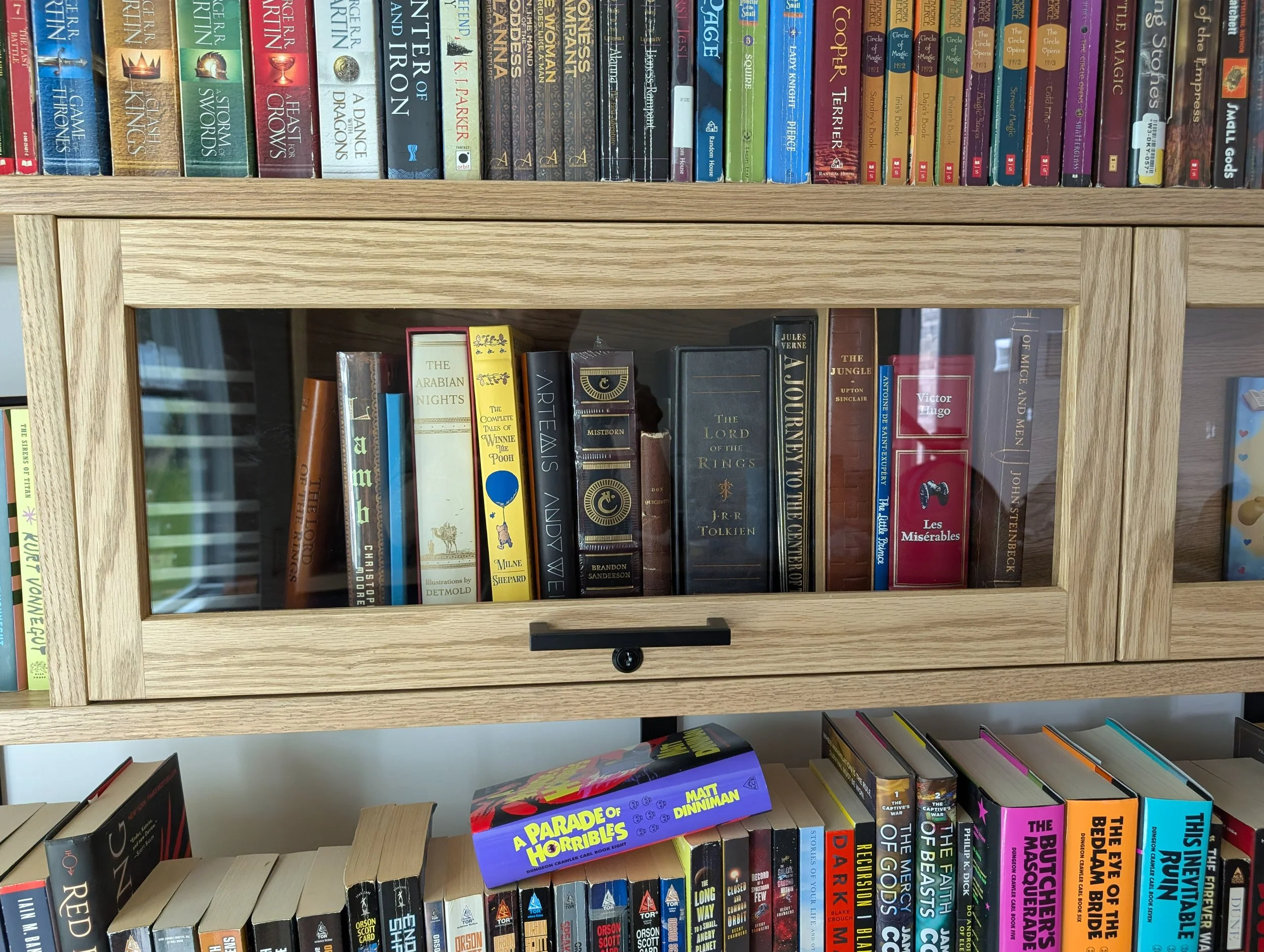 Library with dry bar. White oak shelving, countertops, cabinets and rolling ladder
