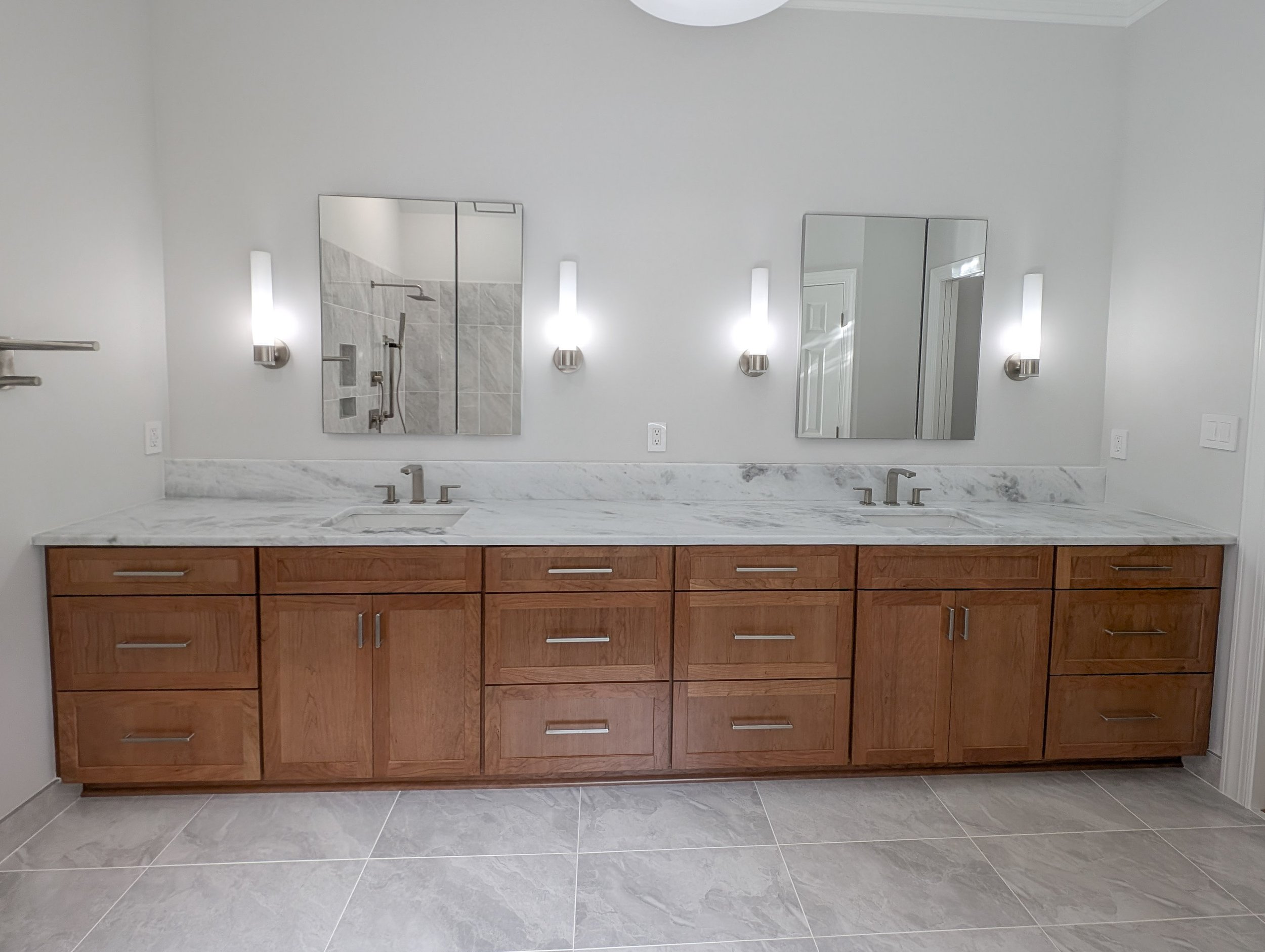 Front view of cabinets with countertops and medicine cabinets