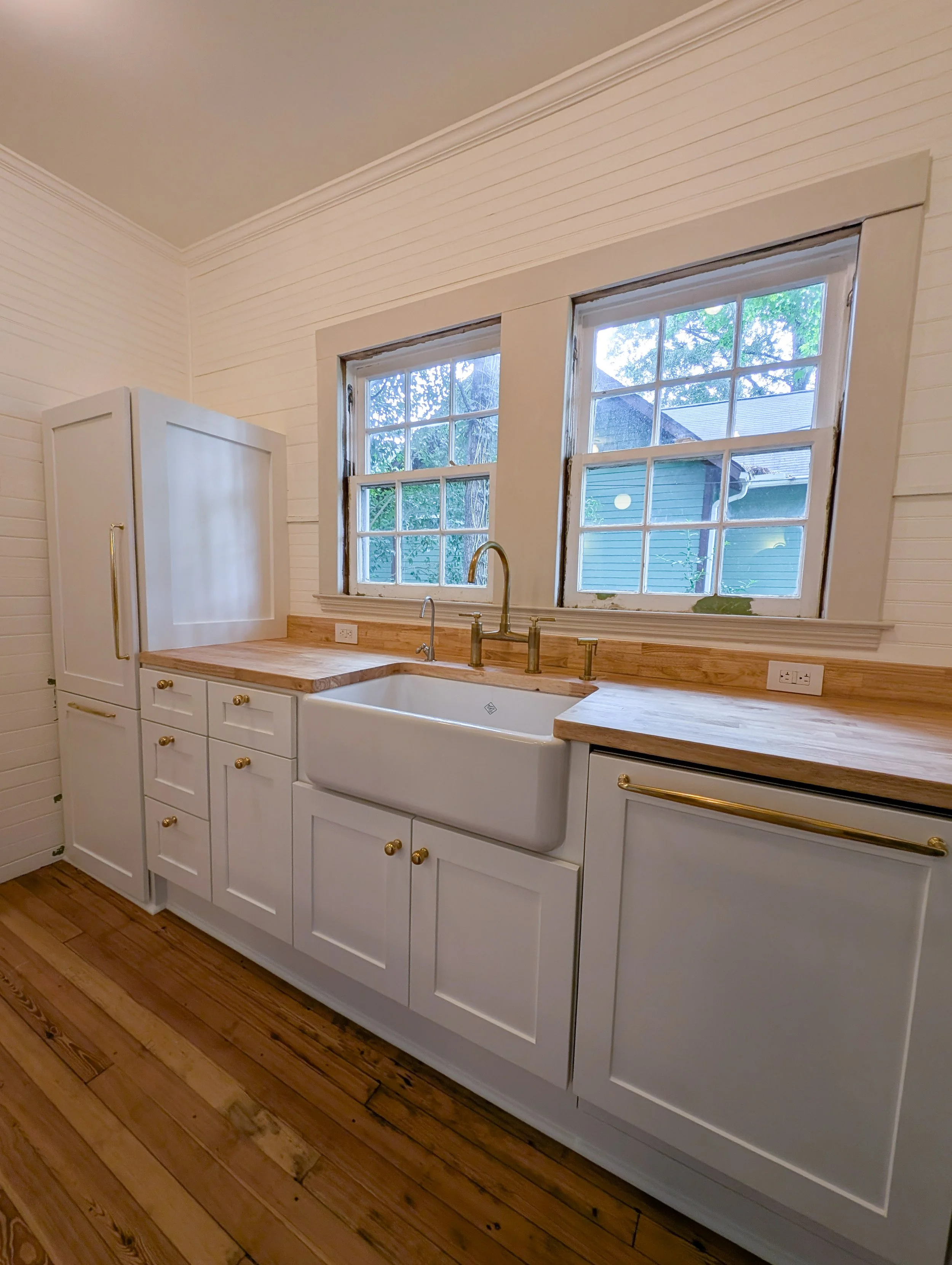 Angled view of sink and surrounding cabinets