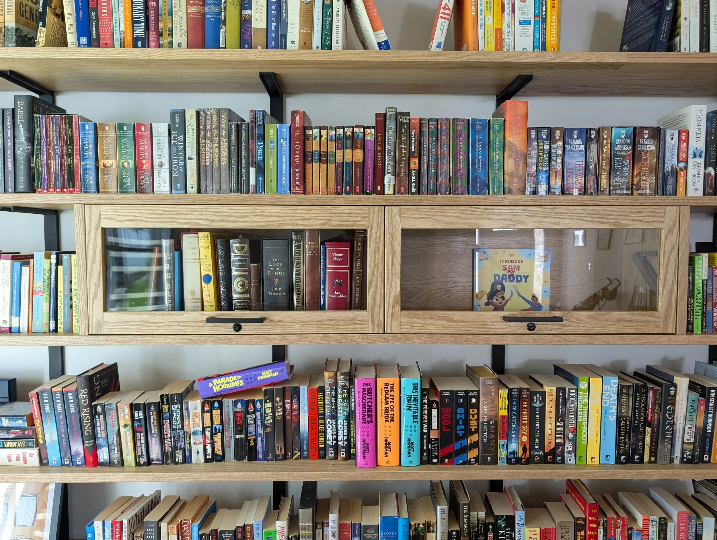 Library with dry bar. White oak shelving, countertops, cabinets and rolling ladder