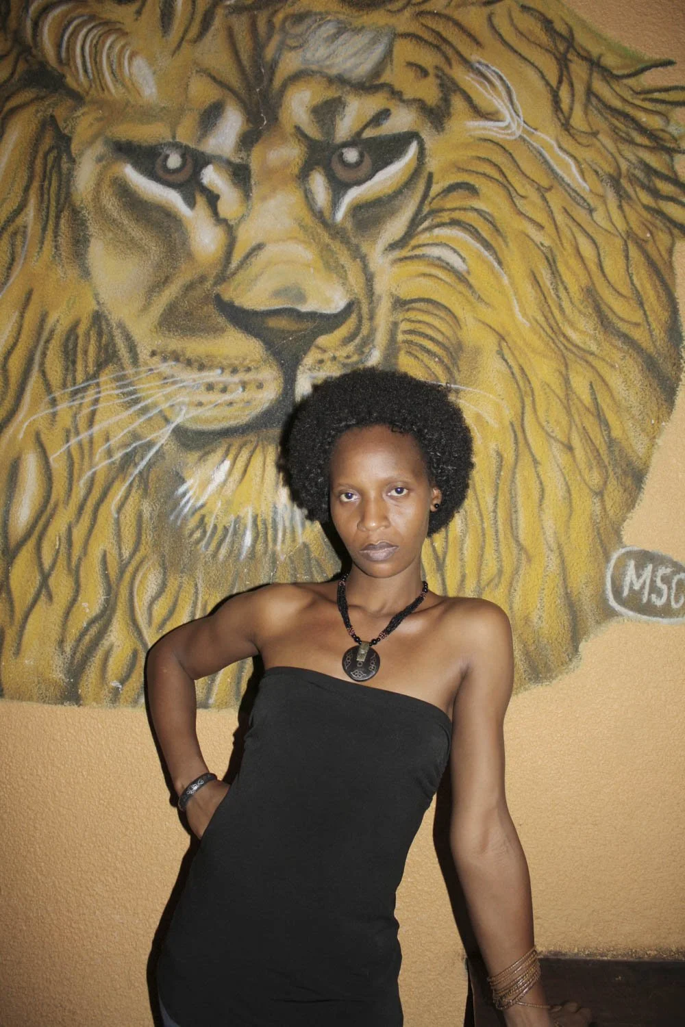 Art and Confidence in Front of a Lion Mural