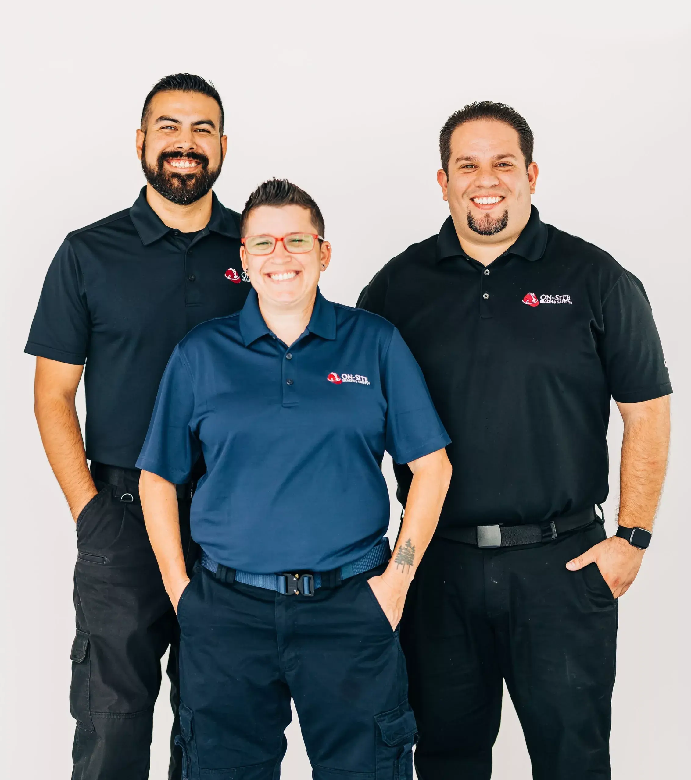 Three smiling people in black and blue uniforms with 'On-site' logos standing against a white background.