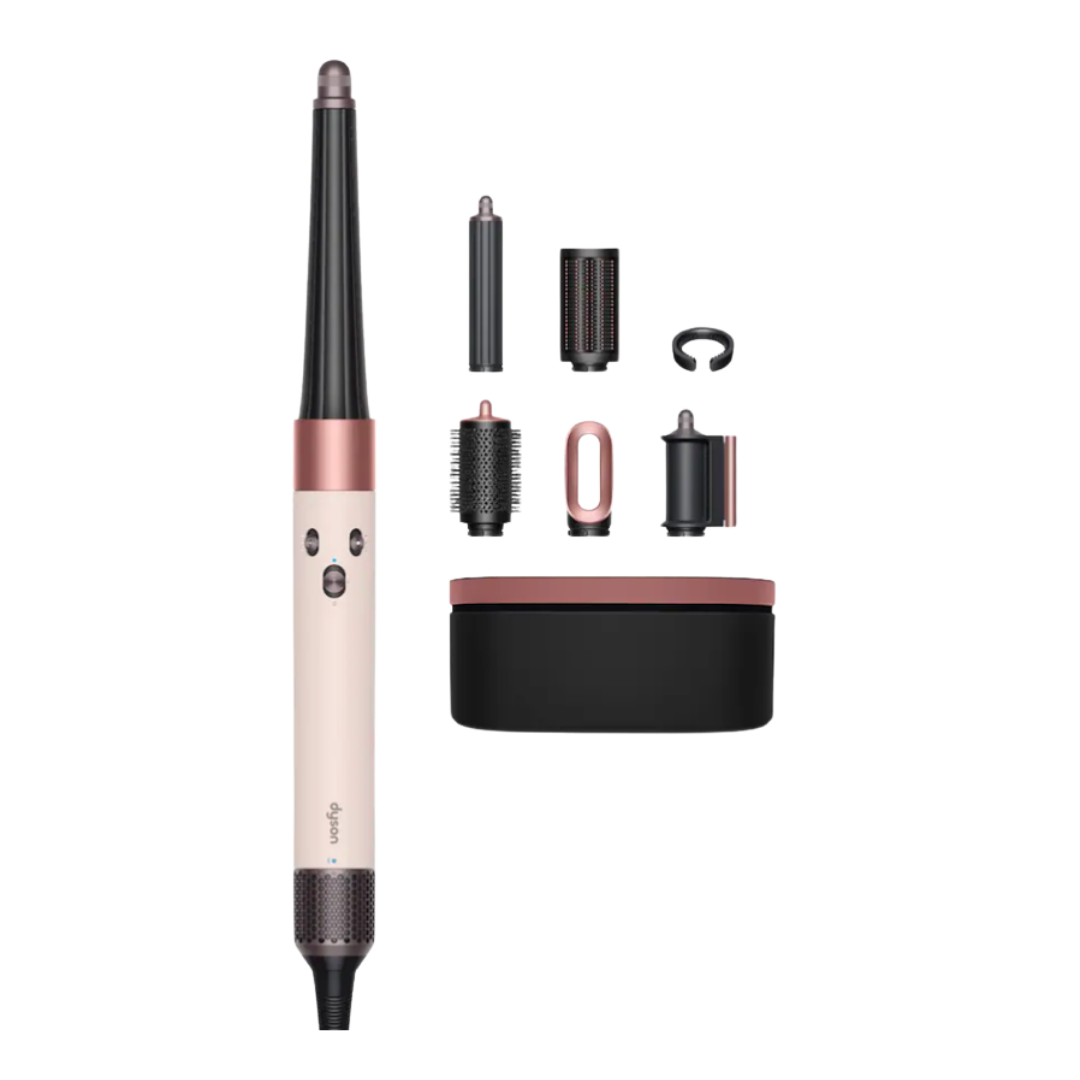 A Dyson Airwrap multi-styler in a soft pink and onyx black finish, shown with several curling and smoothing attachments.