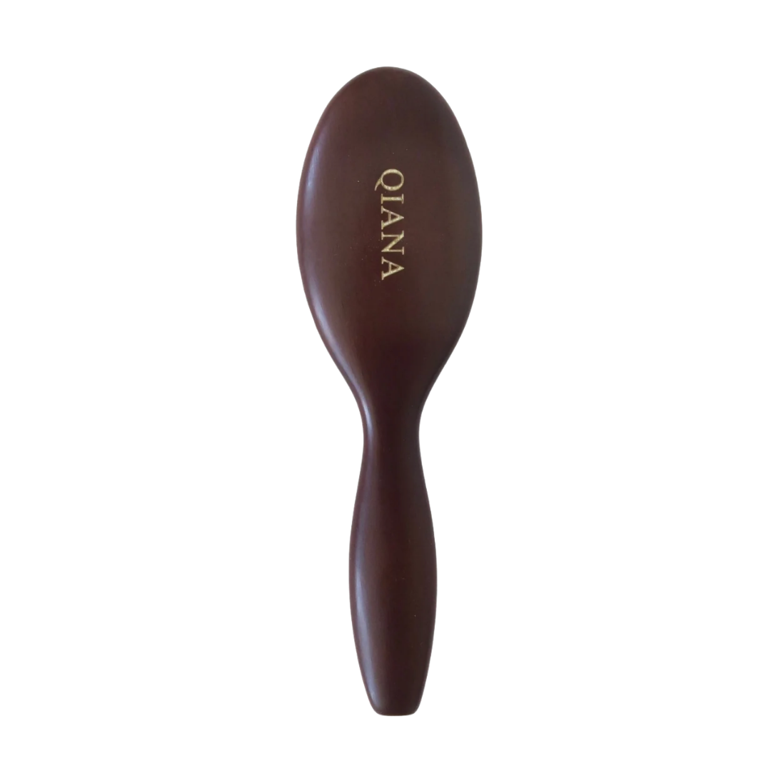 A classic wooden paddle hairbrush in a dark mahogany finish, personalized with the name "QIANA" engraved in gold.