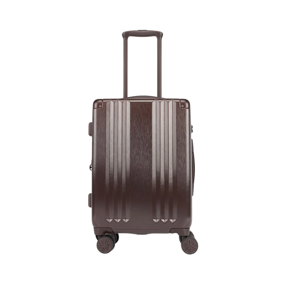 A metallic bronze-colored hardshell carry-on suitcase with a vertical ribbed design and four spinner wheels.