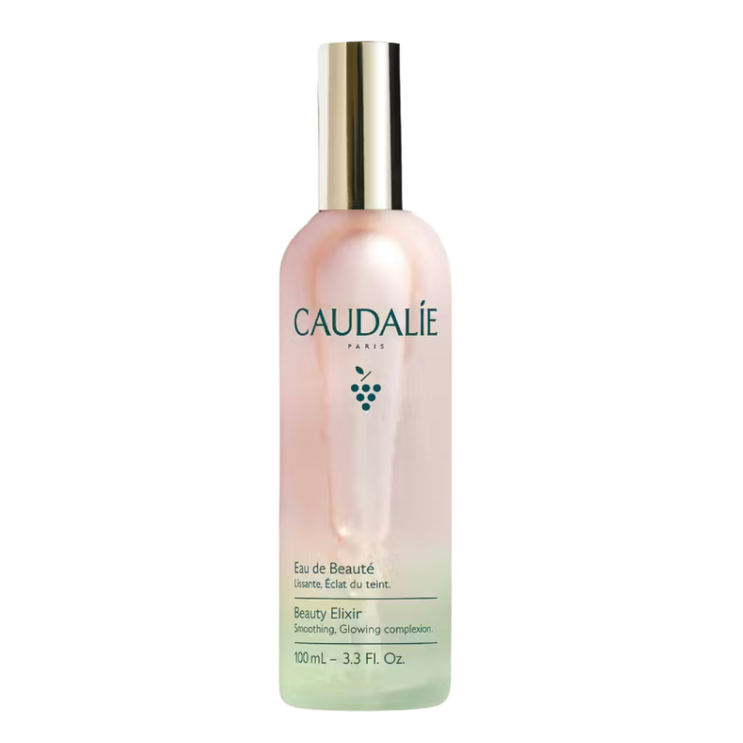 A frosted glass bottle of Caudalie Beauty Elixir mist with a gold cap.