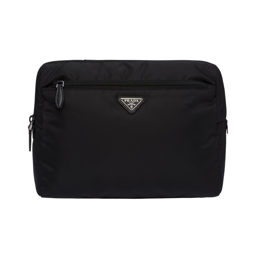 A black Prada nylon cosmetic pouch featuring the iconic silver triangular logo and a front zipper pocket.